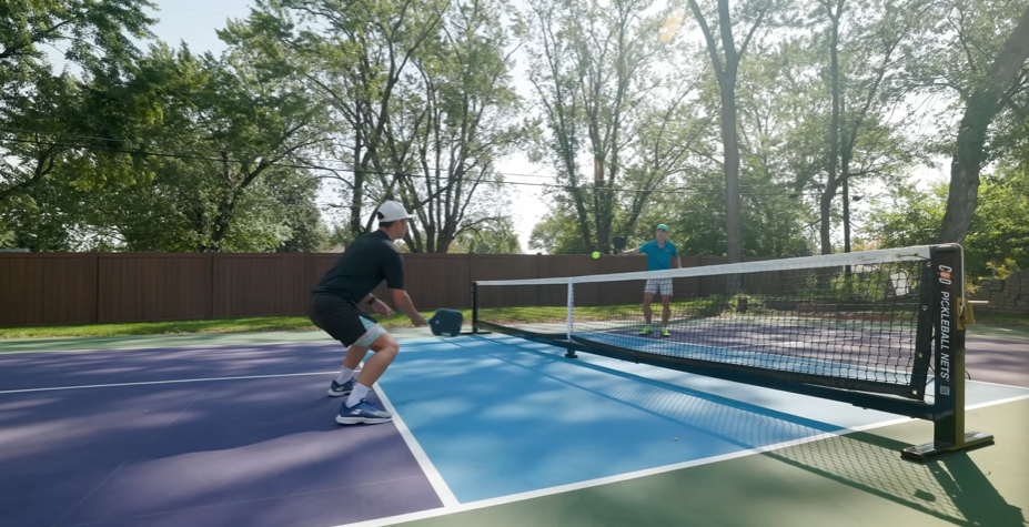 Player hitting a pickleball on an outdoor court during CRBN Waves performance testing