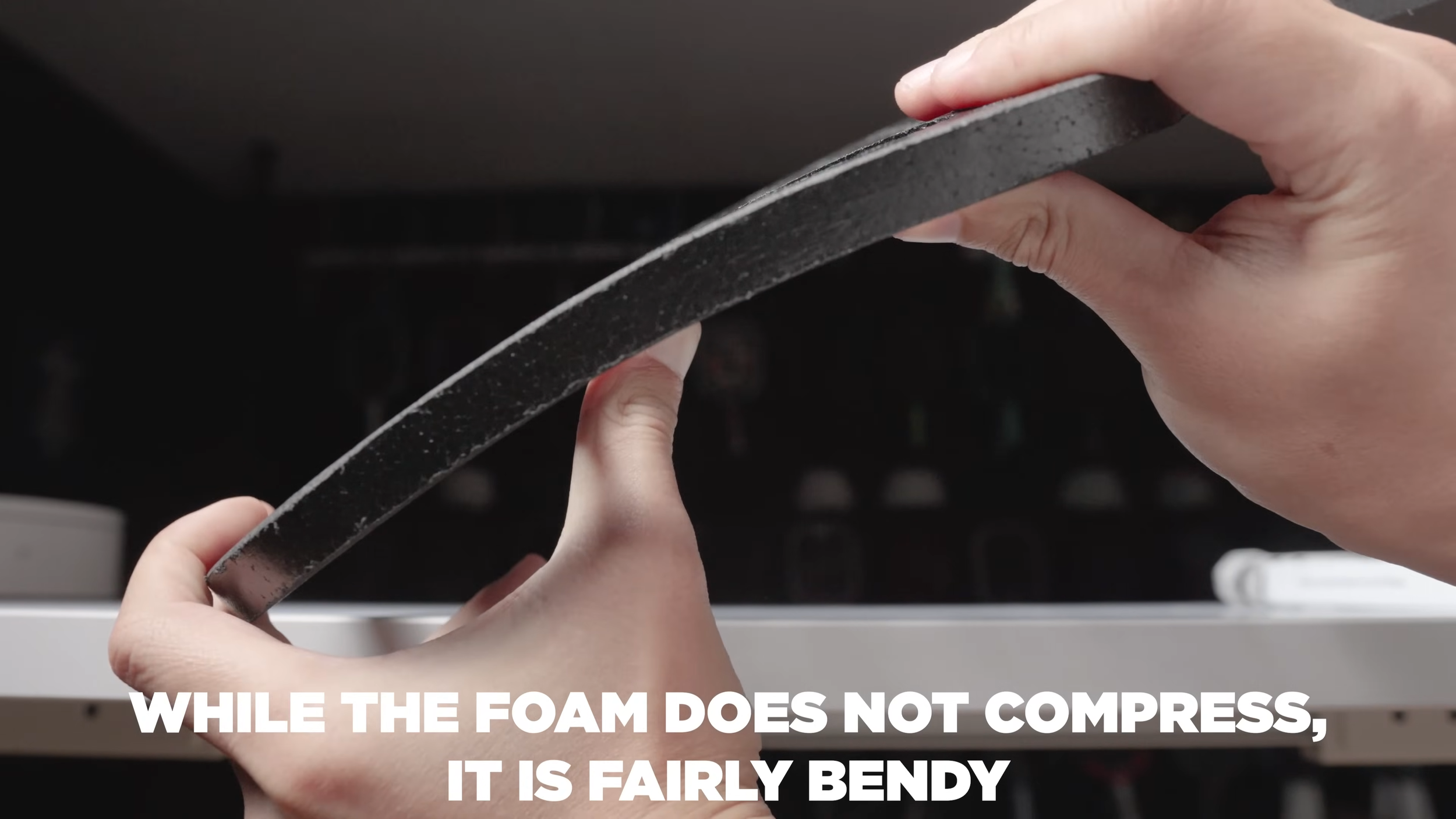 Hands bending the CRBN TruFoam Genesis foam core to demonstrate flexibility of the material