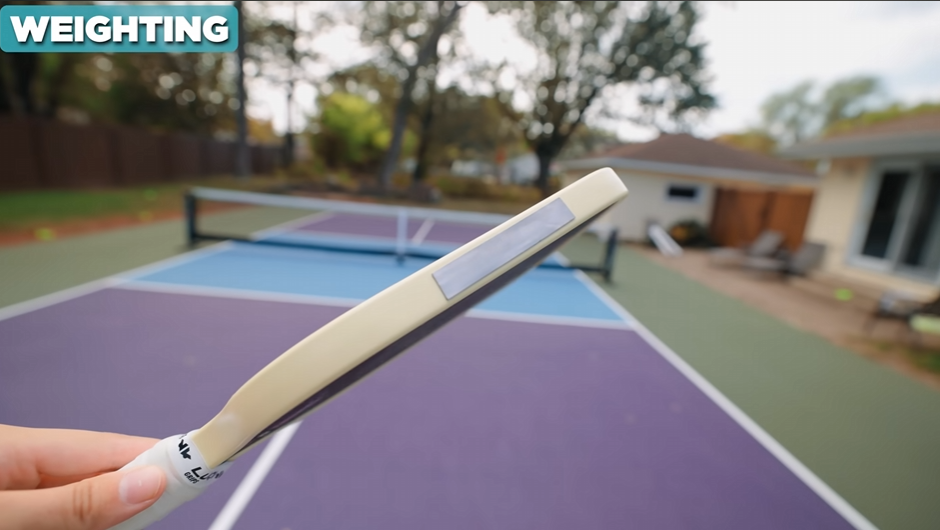 Bread & Butter Loco pickleball paddle edge view showing weight setup with tungsten tape on the court