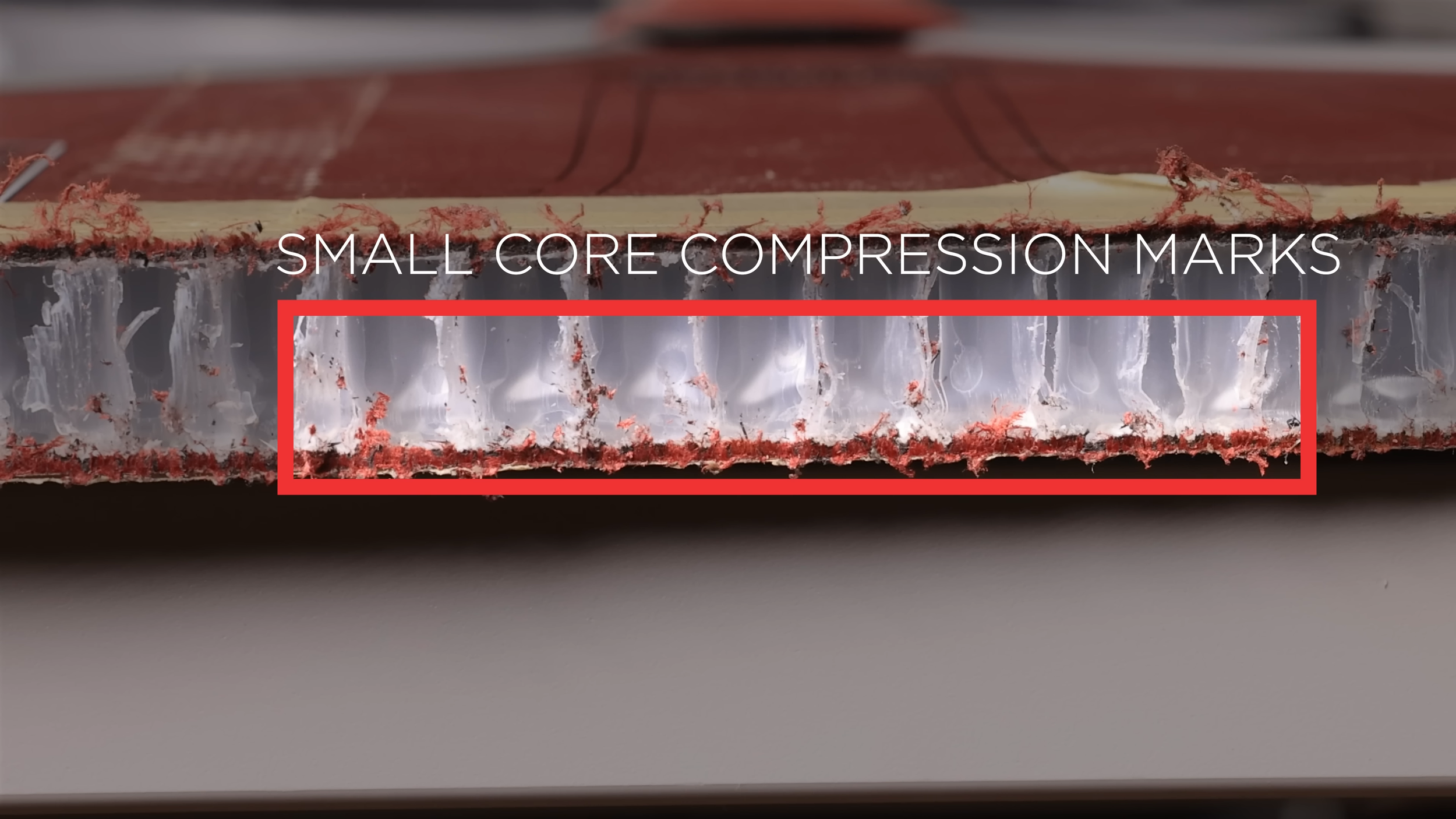 Close-up of Honolulu pickleball paddle cross-section showing small core compression marks in the honeycomb structure