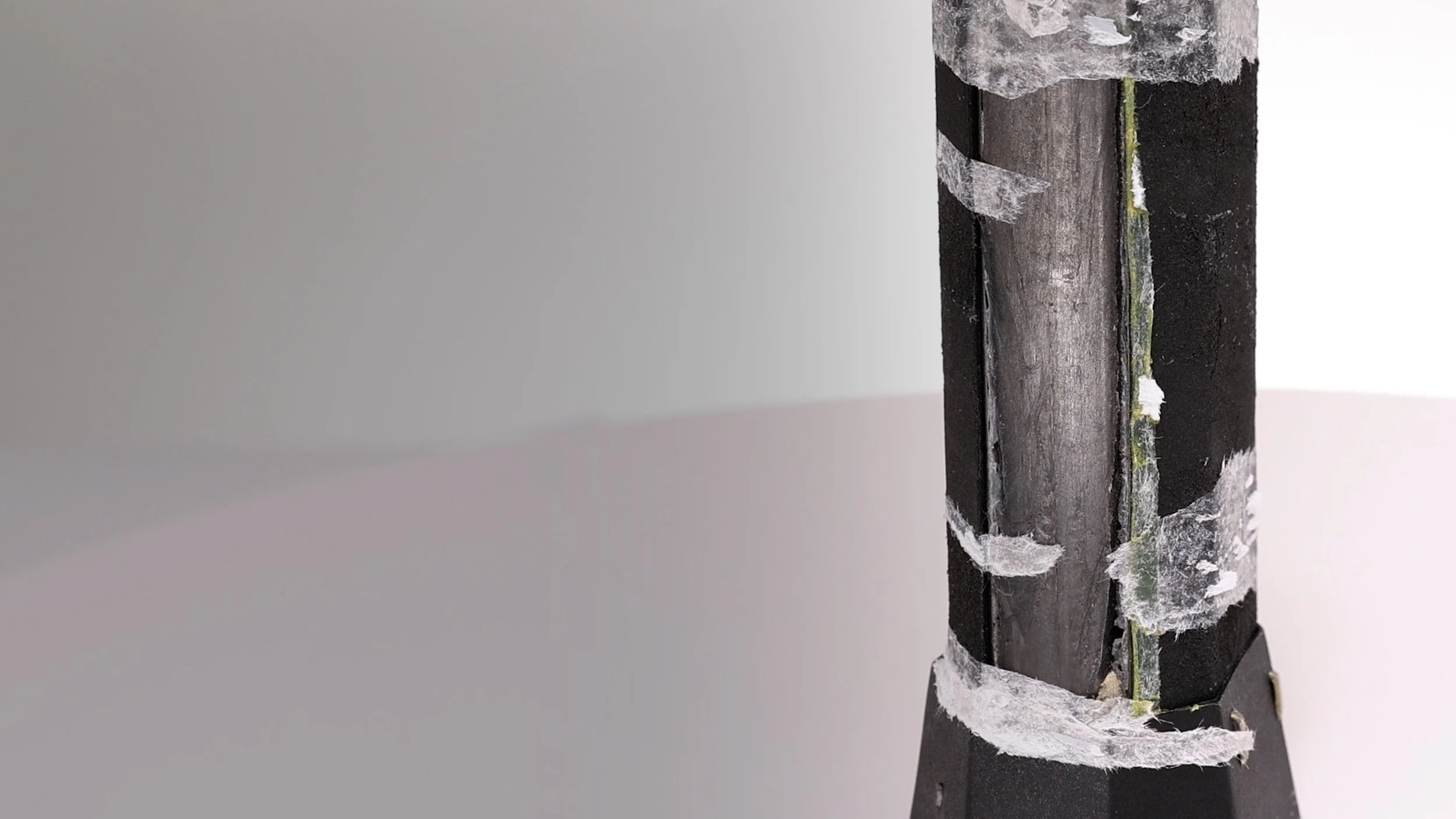 Close-up of JOOLA Ben Johns Perseus pickleball paddle handle showing carbon fiber construction and lead tape