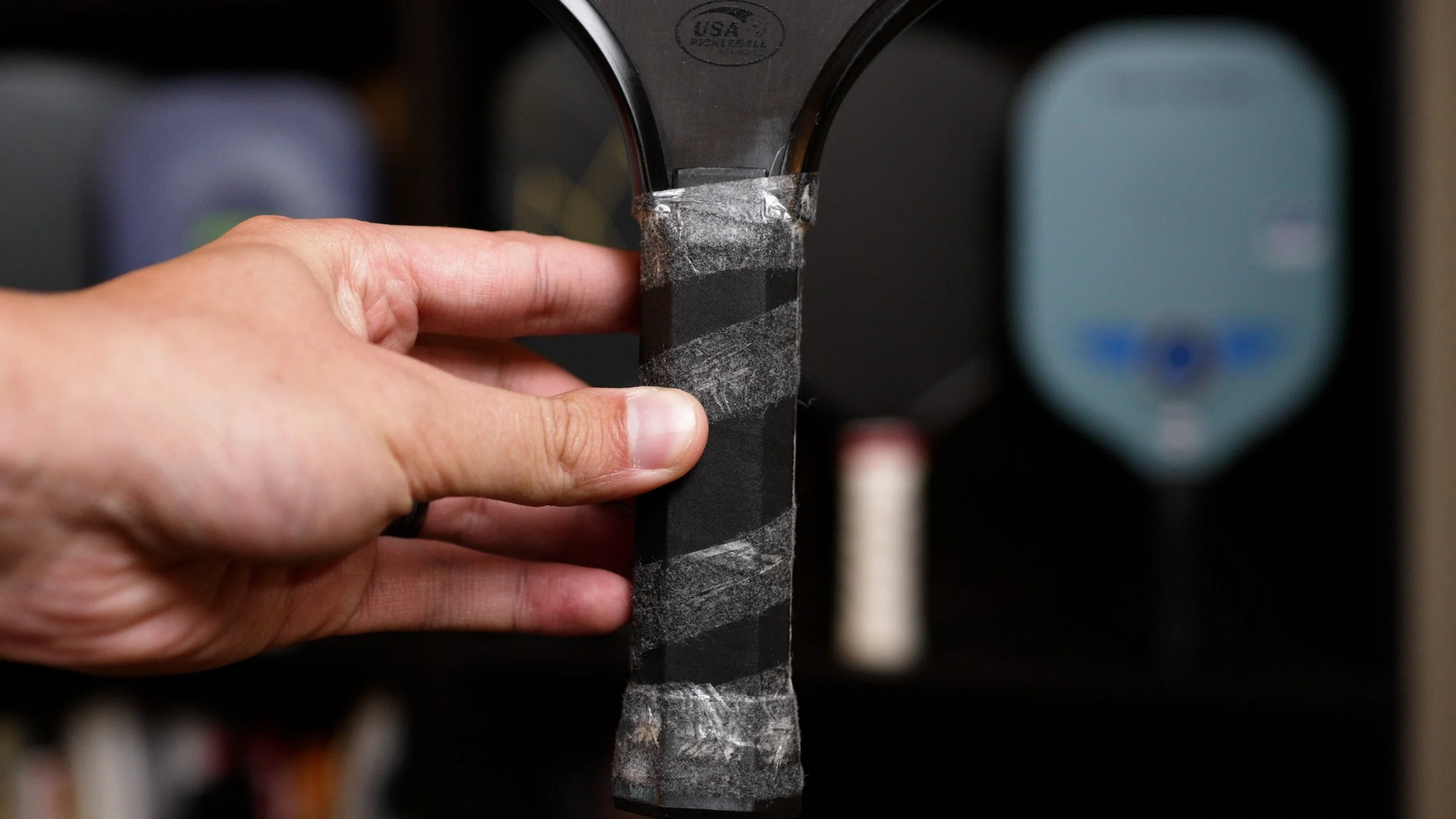 Hand gripping Six Zero Double Black Diamond pickleball paddle handle showing grip size and feel