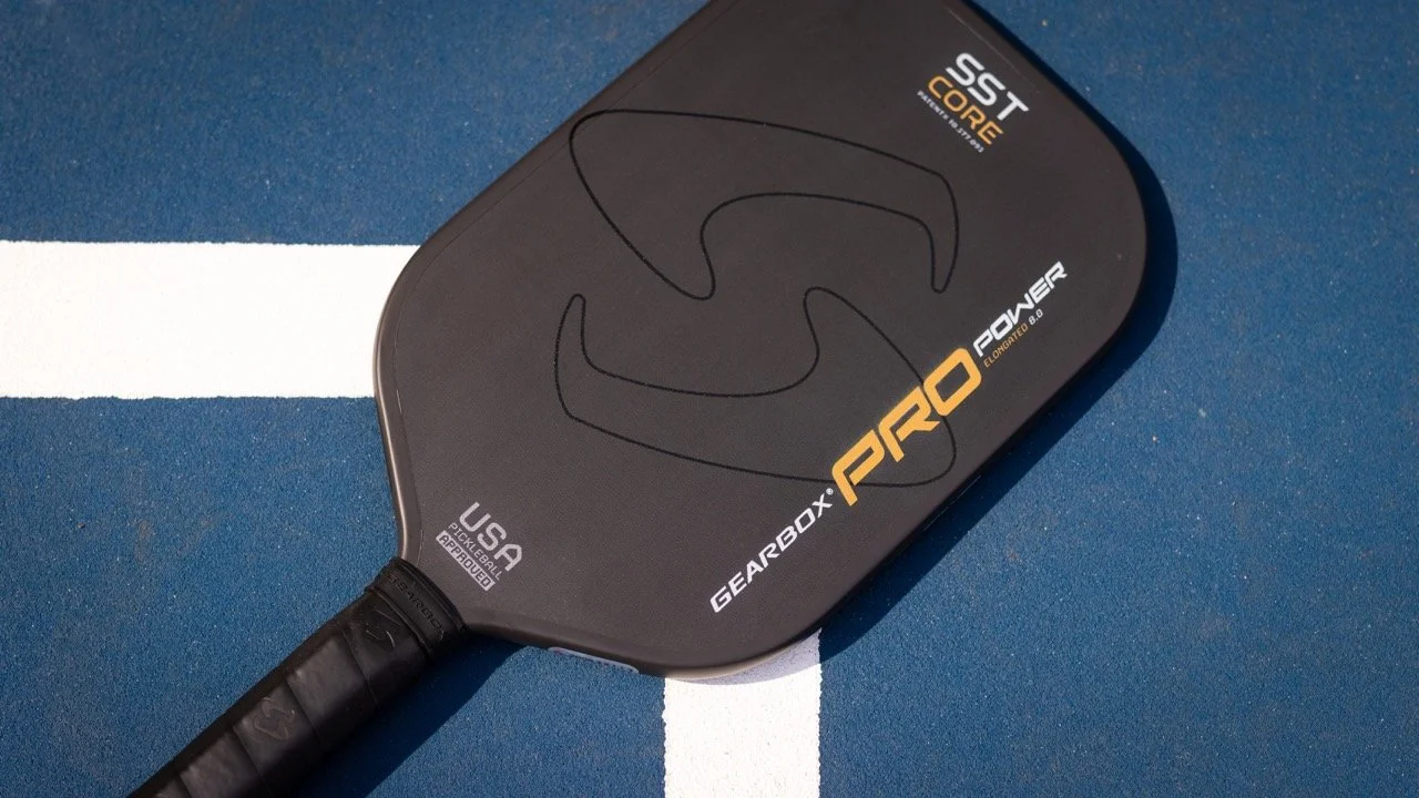 Gearbox Pro Power Elongated pickleball paddle lying on a blue court surface