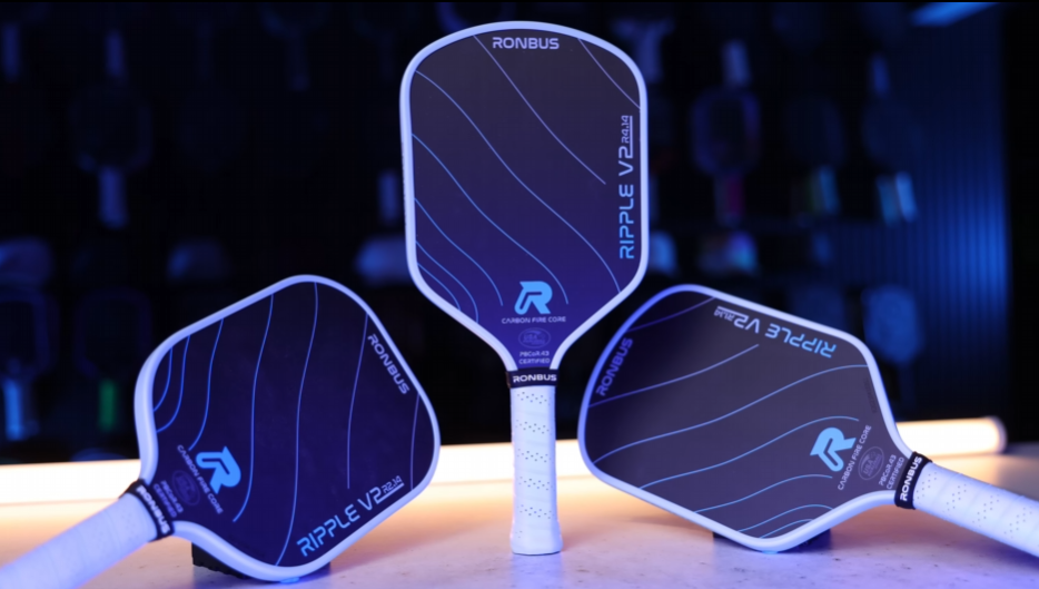 Three Ronbus Ripple V2 pickleball paddles in different shapes displayed with blue accent lighting