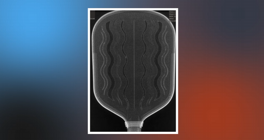 Close-up of the CRBN Waves pickleball paddle face showing wavy texture pattern