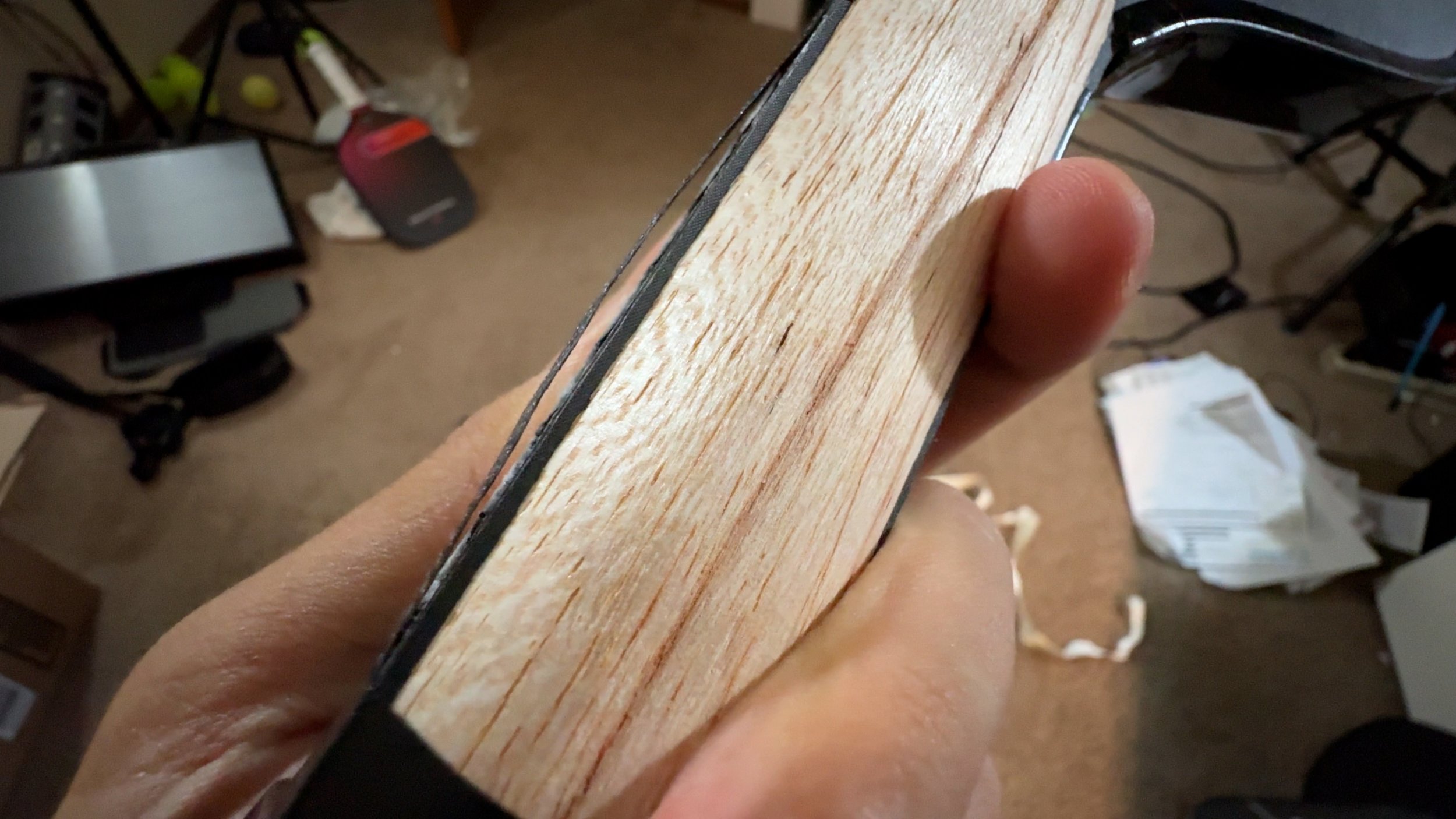 Engage Pursuit Pro pickleball paddle handle close-up showing exposed wood construction