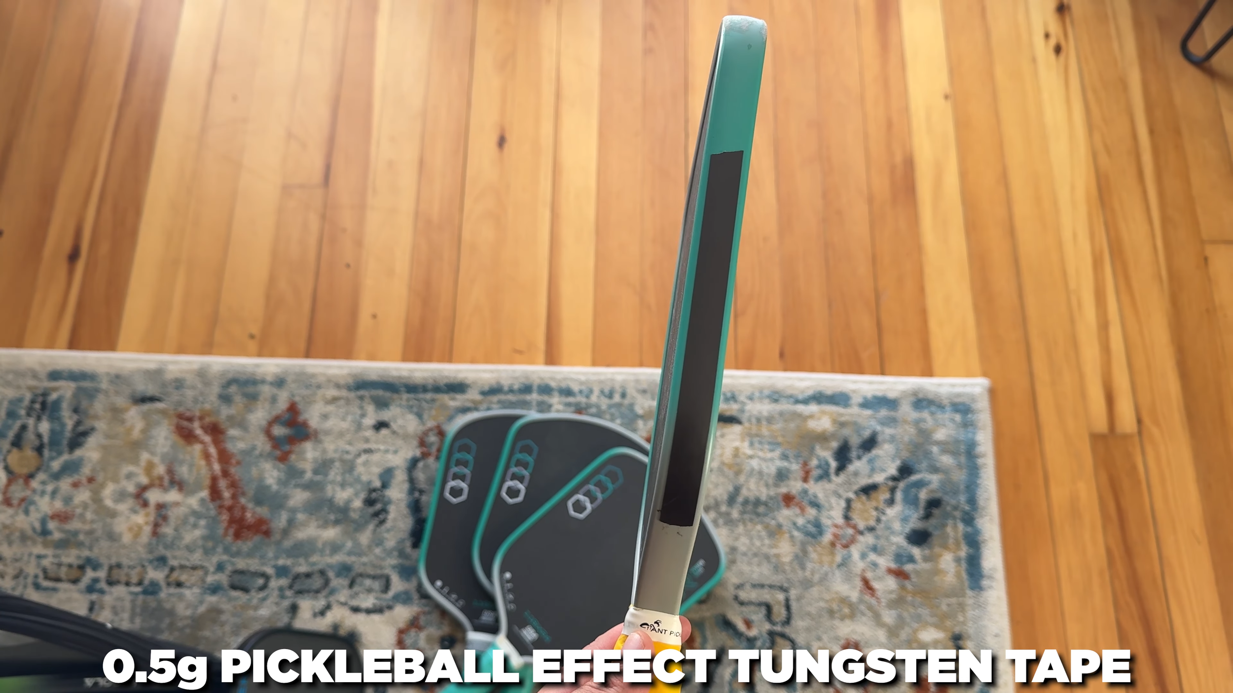 11SIX24 Power Series pickleball paddle edge view with 0.5g tungsten tape weight setup applied