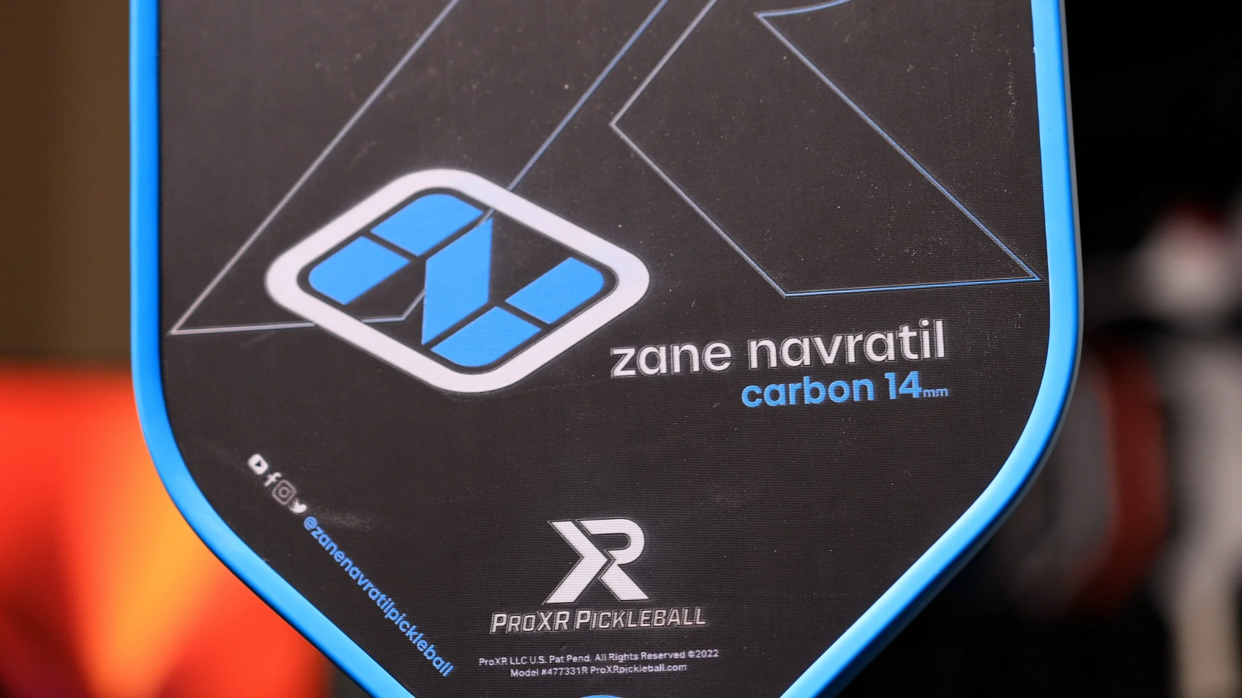 Close-up of ProXR Zane Navratil Carbon 14 pickleball paddle face showing logo and branding