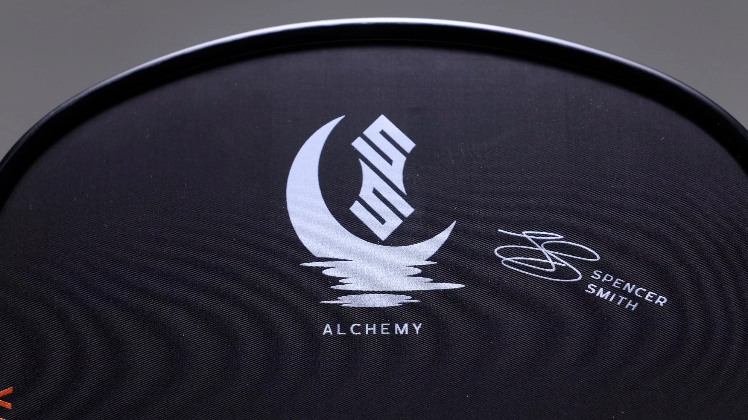 Close-up of Vatic Pro Alchemy pickleball paddle face showing Spencer Smith signature and moon logo Close-up of Vatic Pro Alchemy pickleball paddle face showing Spencer Smith signature and moon logo