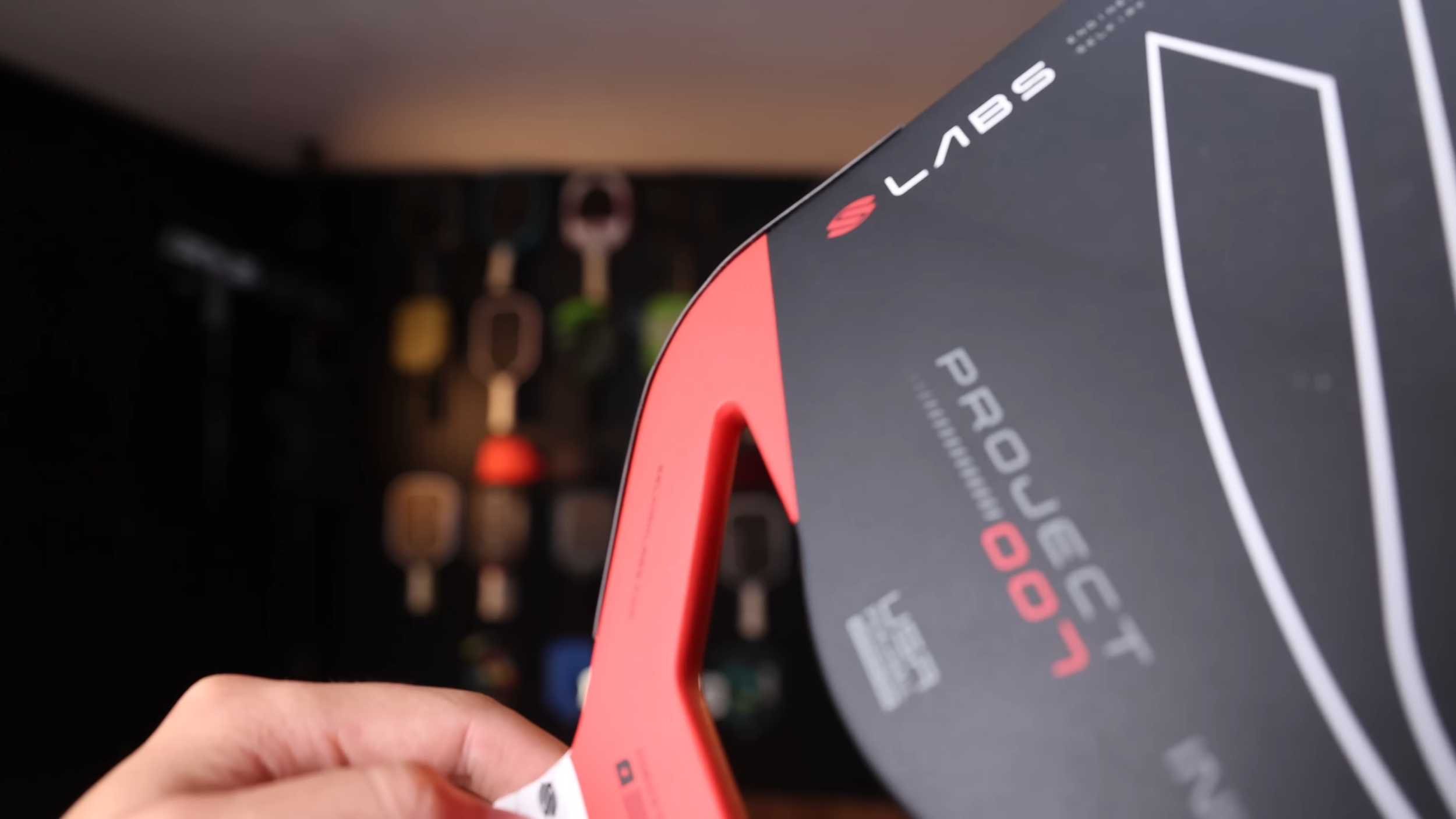 Close-up of Selkirk Labs Project 007 red open-throat handle design held in hand