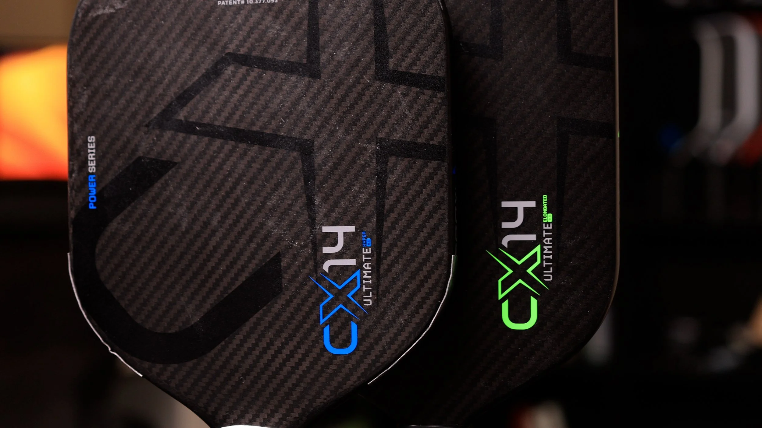 Two Gearbox CX14 Ultimate pickleball paddles in blue and green colorways with SST Core technology