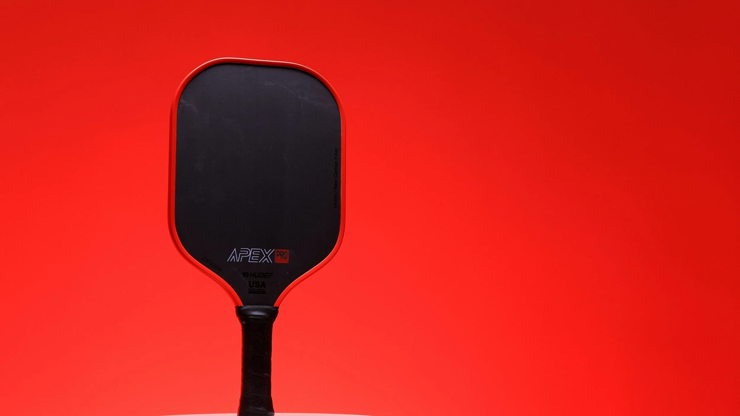 Hudef Apex Pro pickleball paddle on red background