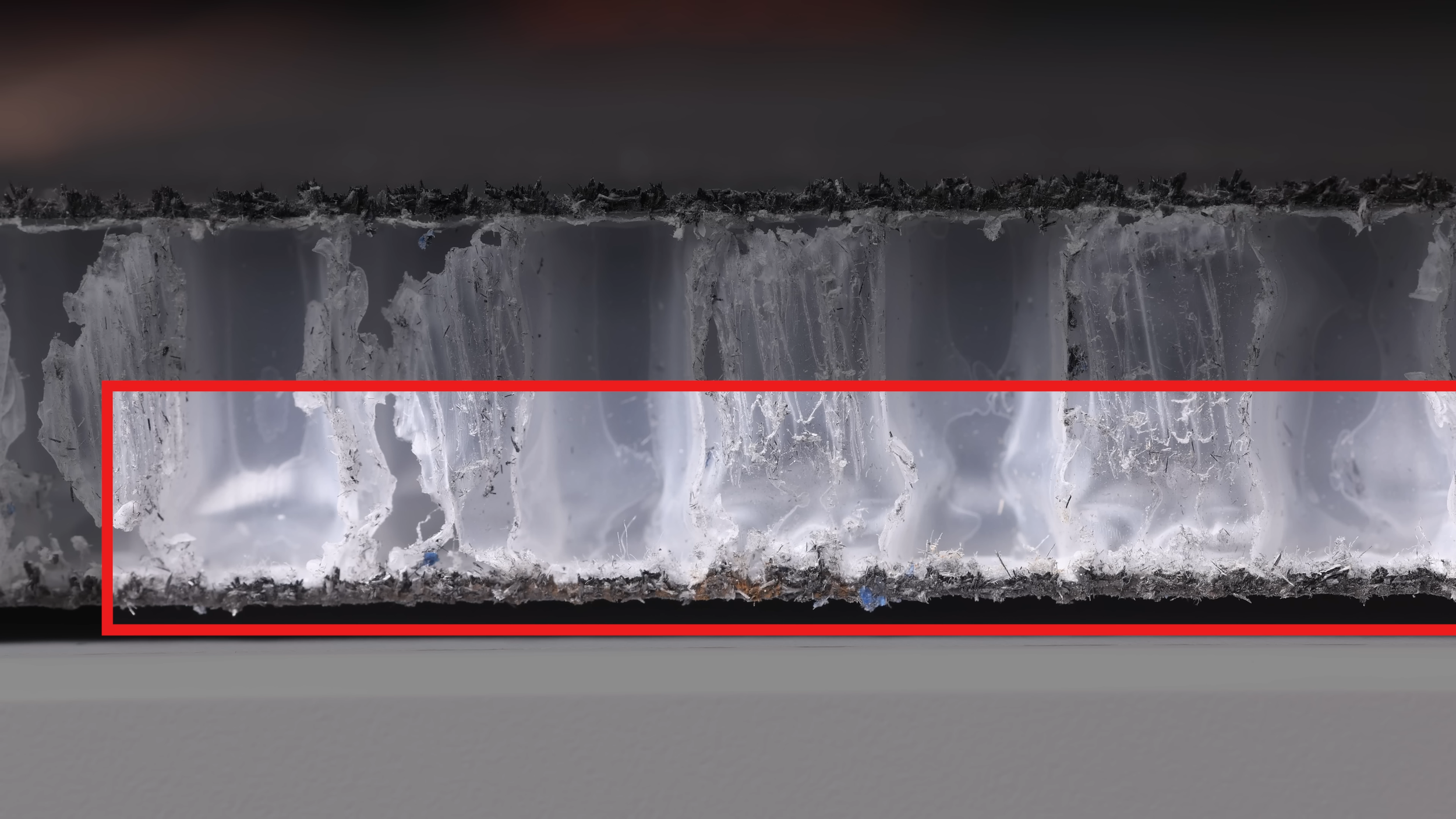 Cross-section teardown of Vatic Pro Saga pickleball paddle showing polymer honeycomb core layers