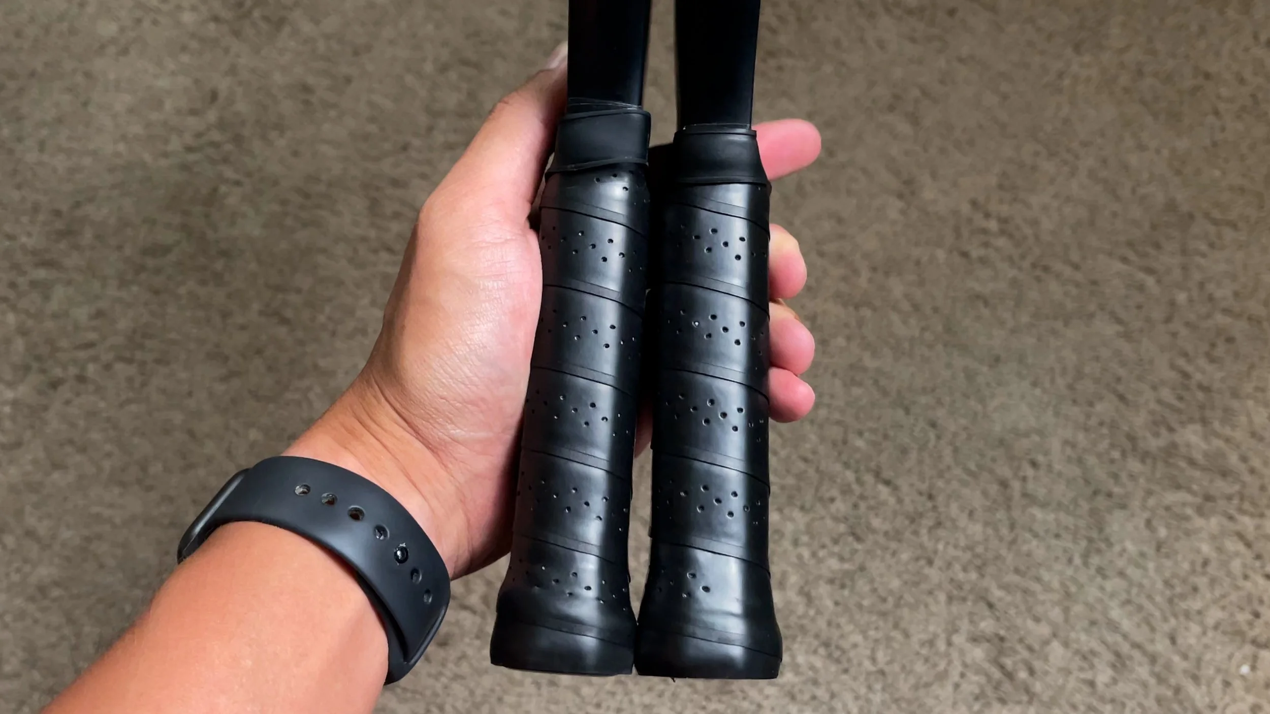 Hand holding two Vatic Pro Alchemy pickleball paddle handles showing grip comparison Hand holding two Vatic Pro Alchemy pickleball paddle handles showing grip comparison