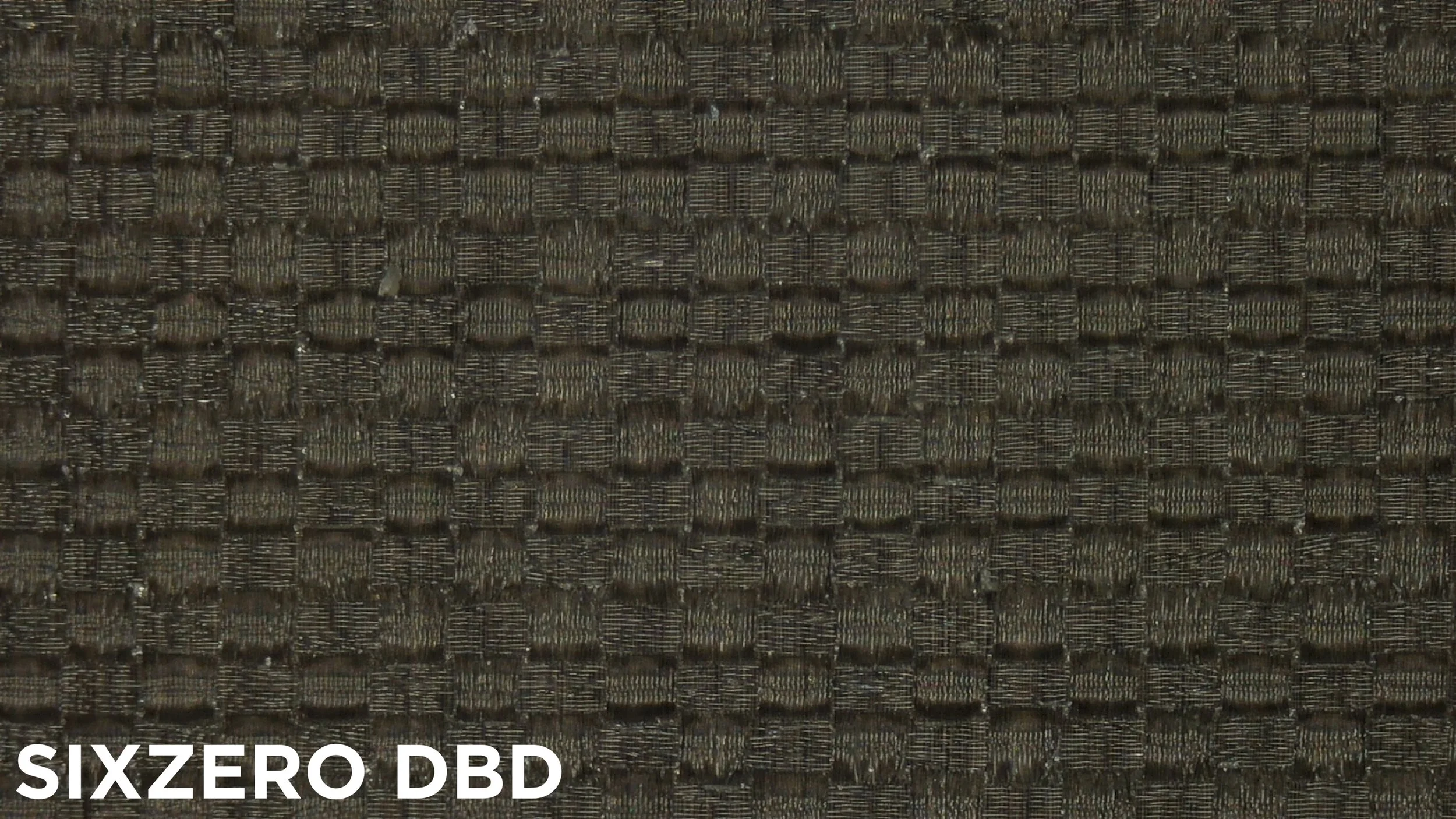 Macro close-up of SixZero DBD pickleball paddle carbon fiber surface texture for spin comparison