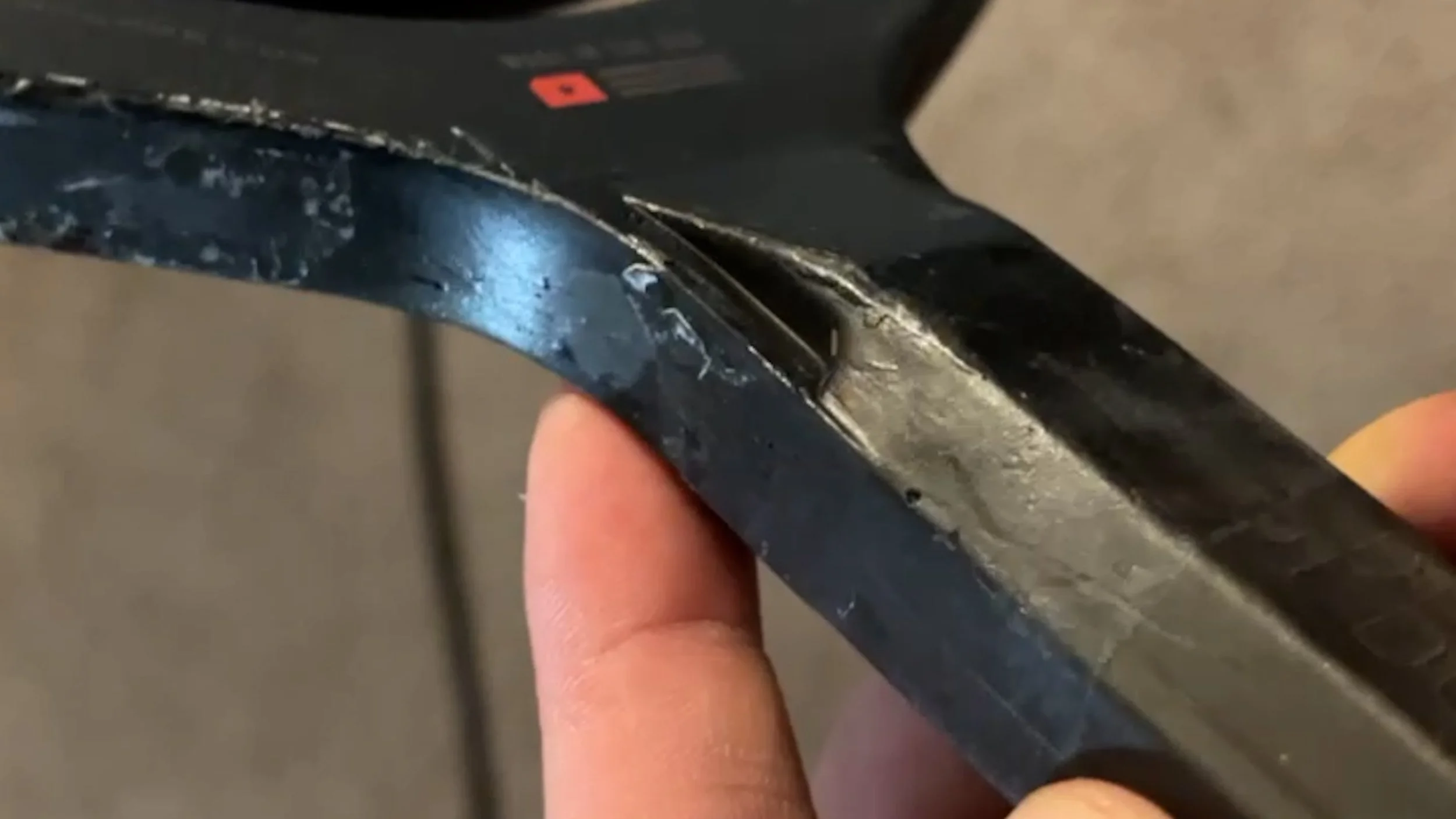 Close-up of JOOLA Ben Johns Perseus pickleball paddle edge guard showing wear and construction detail