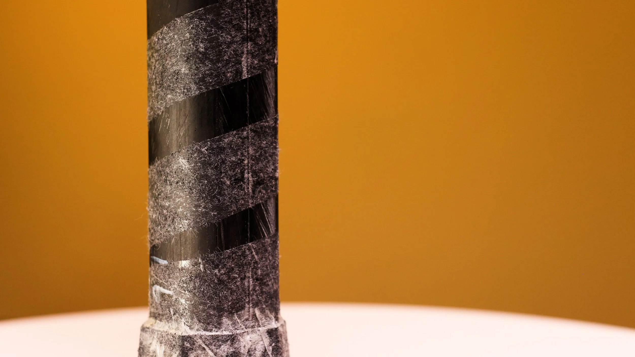 Electrum Model E Elite pickleball paddle handle close-up showing chunky carbon fiber construction