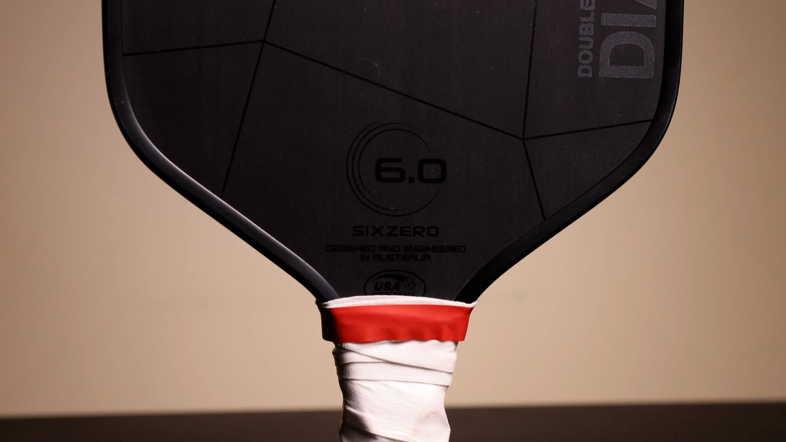 Six Zero Double Black Diamond 16mm pickleball paddle handle and throat area with white overgrip