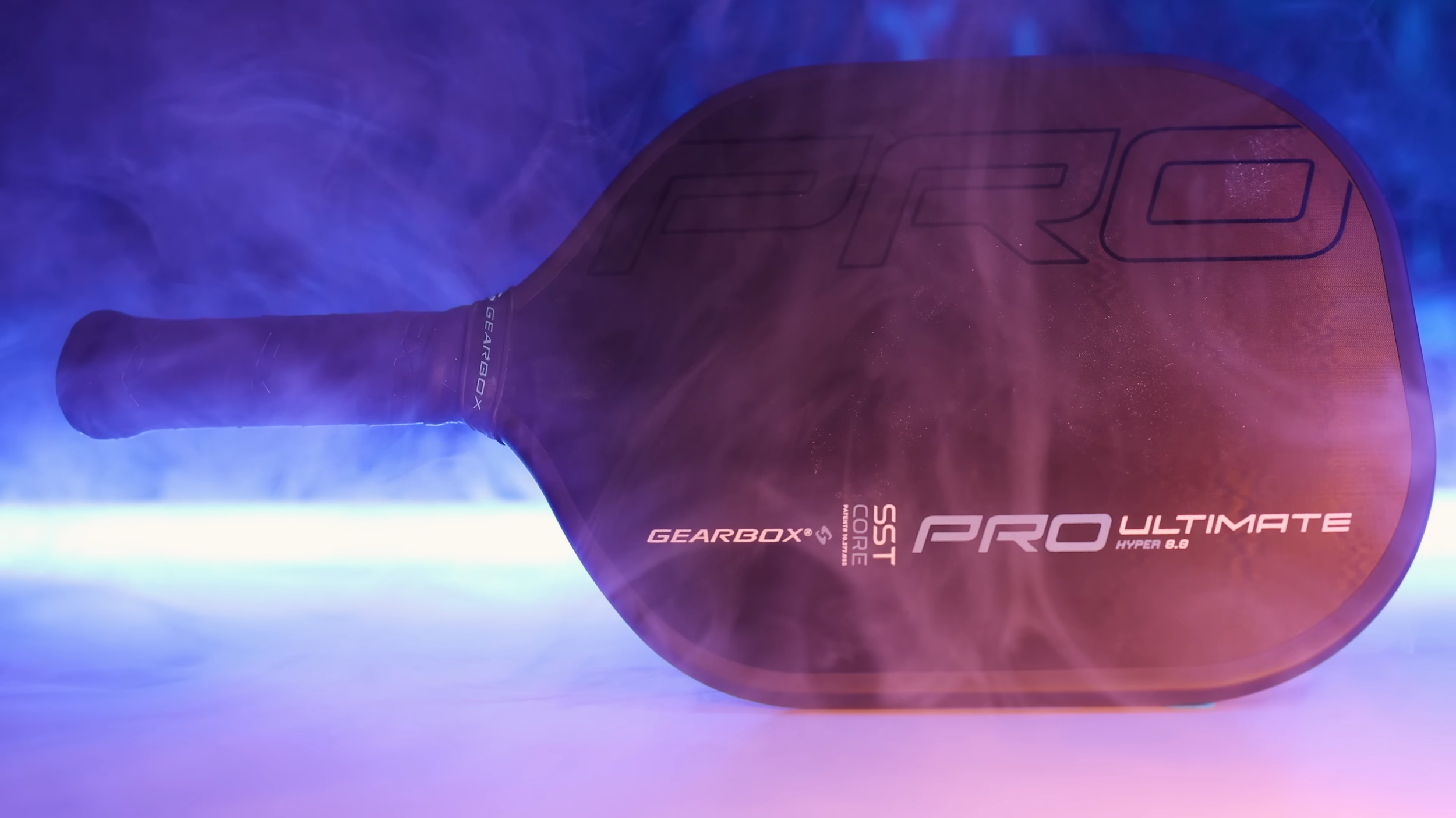 Gearbox Pro Ultimate Hyper pickleball paddle with dramatic blue and purple lighting and smoke effects