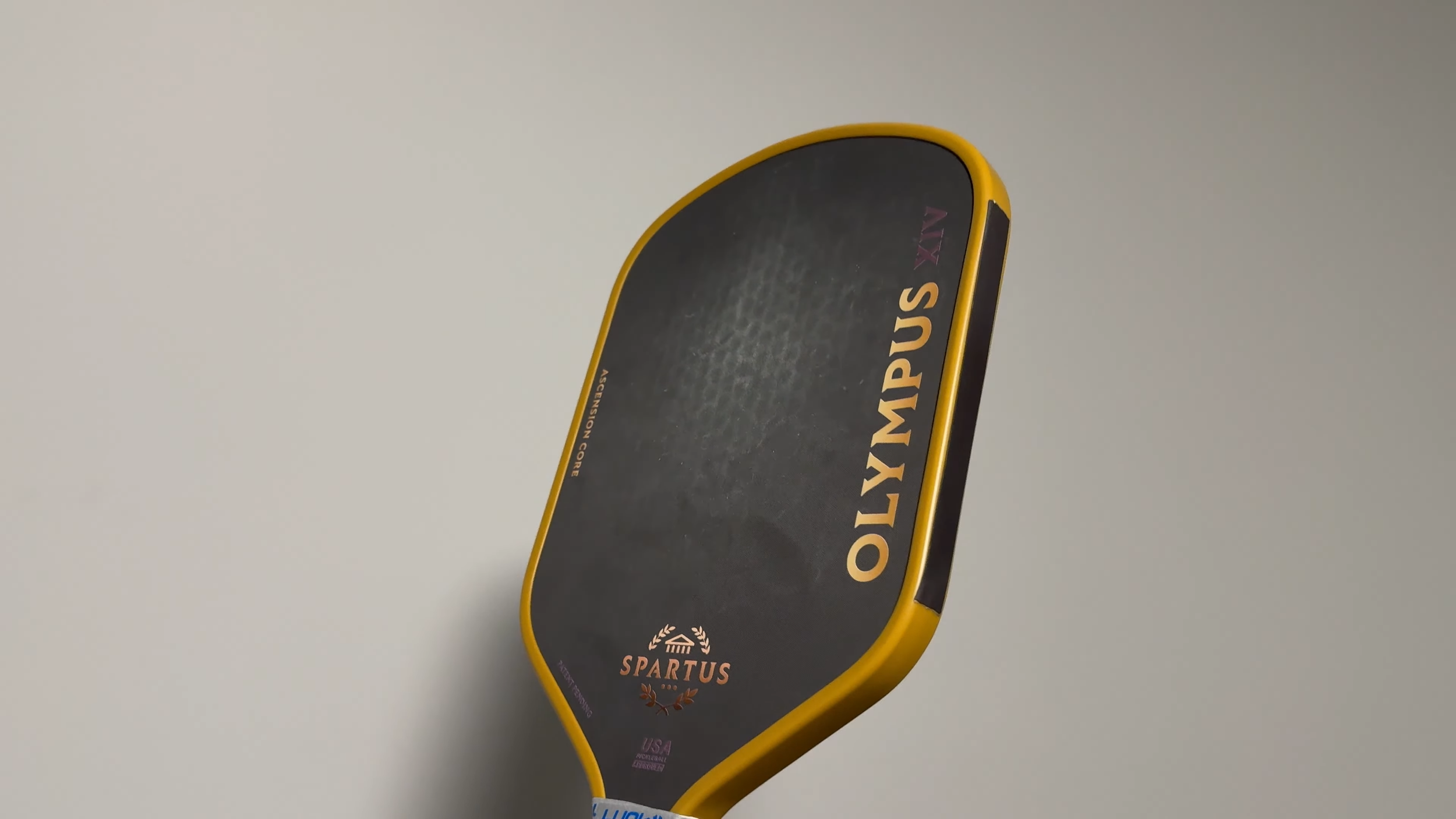 Spartus Olympus XIV pickleball paddle angled view showing carbon fiber face and gold trim