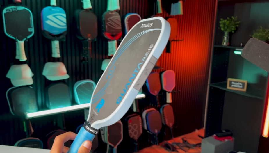 Ronbus Quanta pickleball paddle held up showing elongated shape with lead tape weight setup
