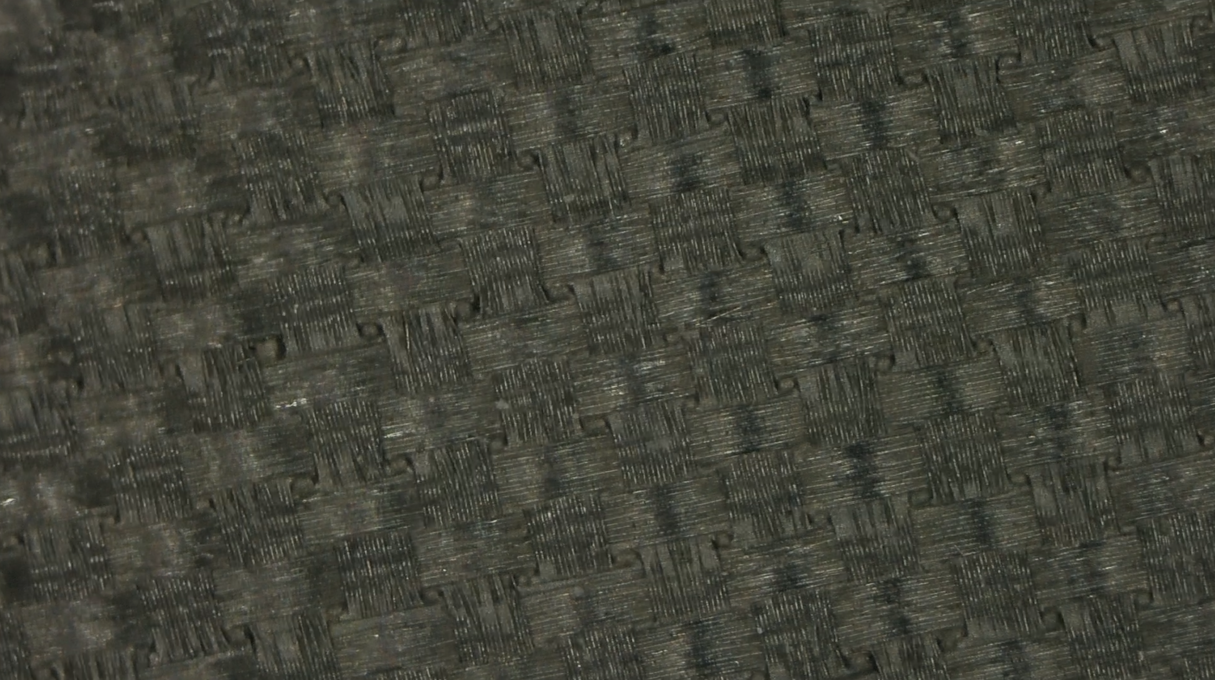 Extreme macro close-up of JOOLA Hyperion CFS pickleball paddle woven carbon fiber surface texture