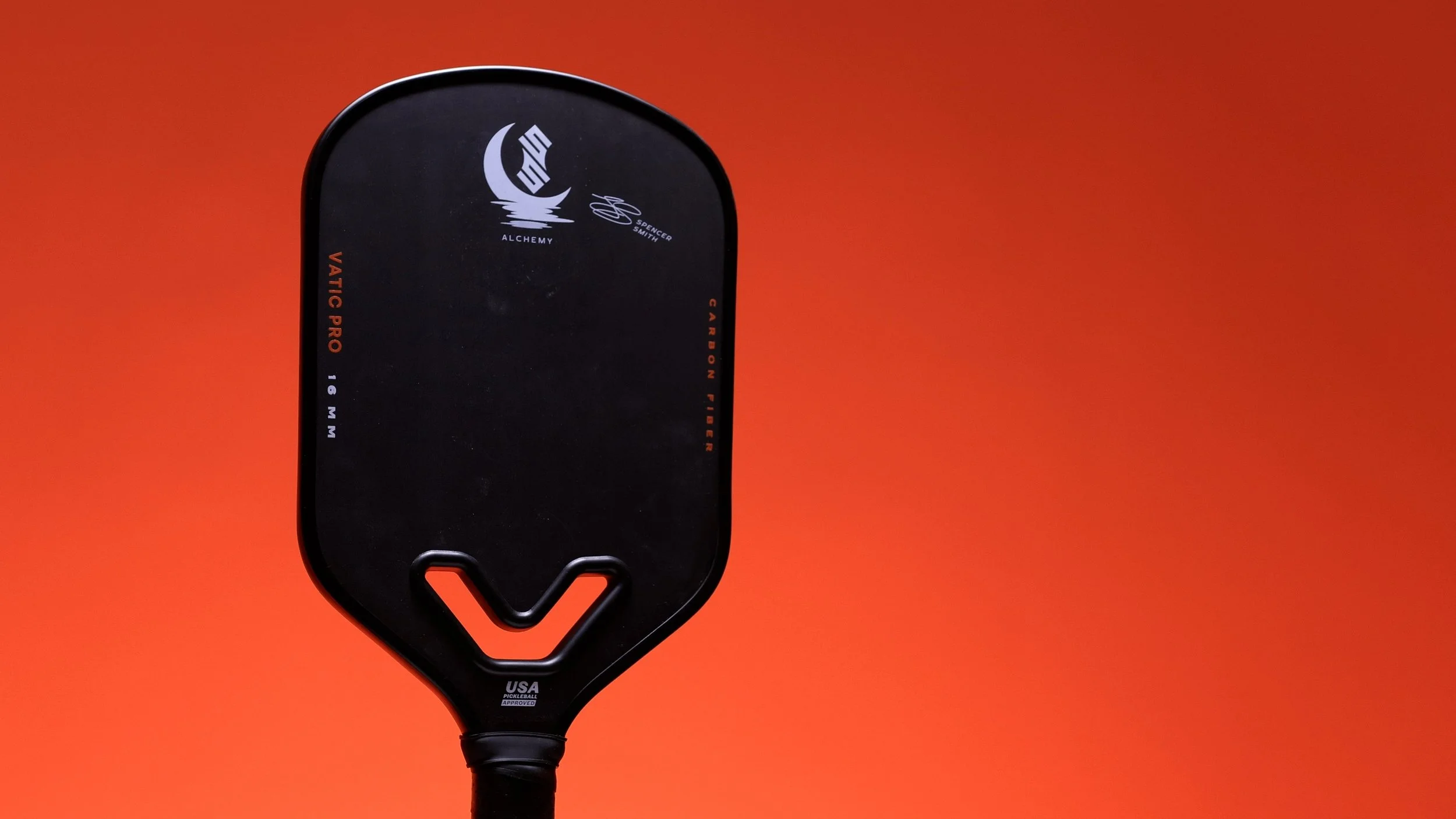 Vatic Pro Alchemy 16mm pickleball paddle with Spencer Smith signature on orange background Vatic Pro Alchemy 16mm pickleball paddle with Spencer Smith signature on orange background
