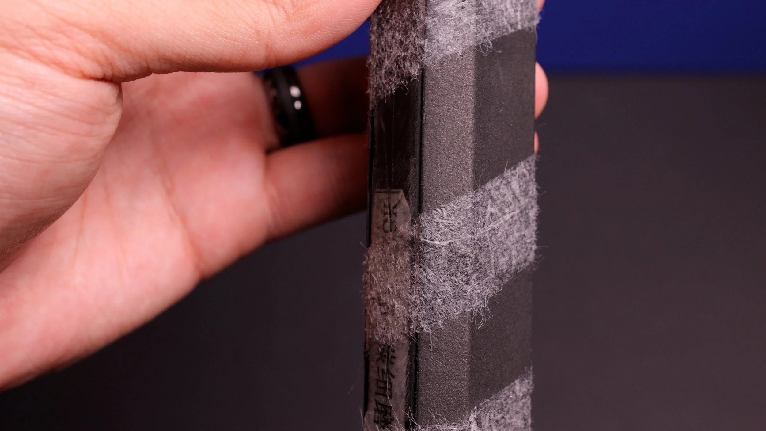 CRBN 1X 16mm pickleball paddle handle close-up showing raw carbon fiber construction and grip texture