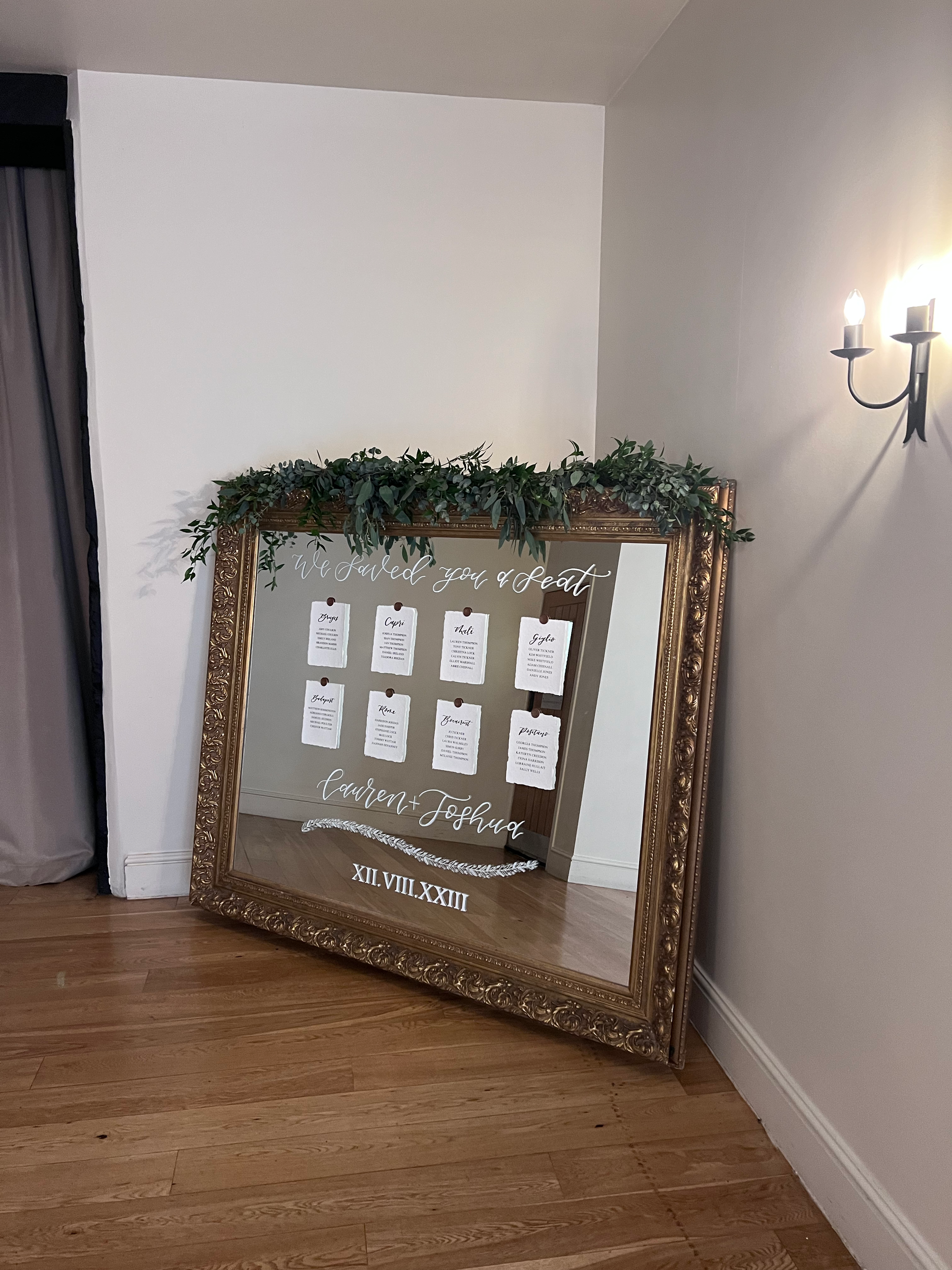 The Granary Estates wedding venue mirror seating plan with handmade paper tables and modern calligraphy