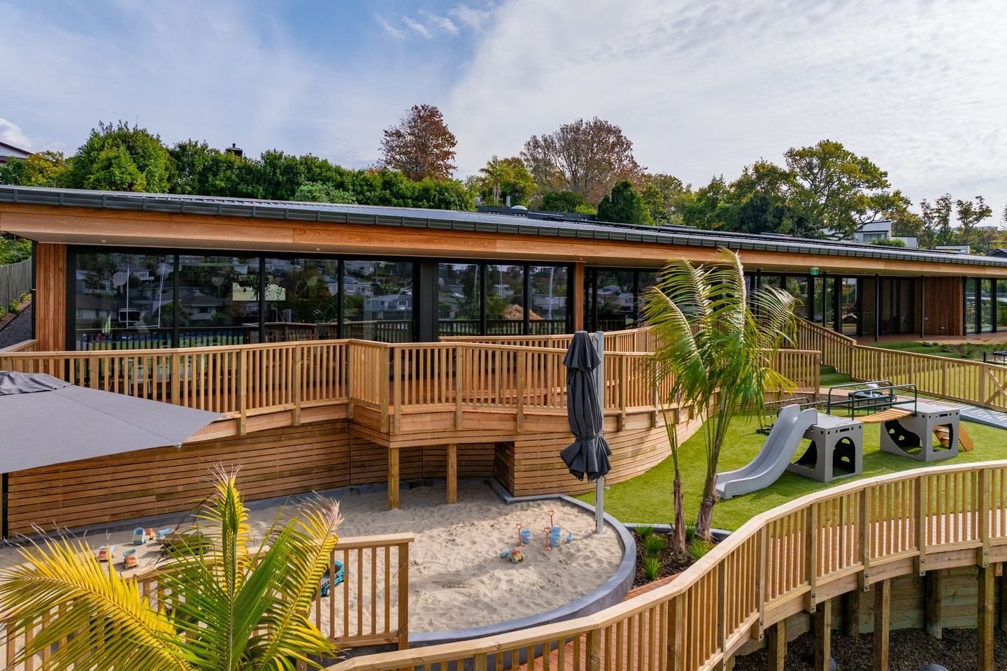The fencing for this outdoor playscape isn&rsquo;t a common boundary but rather a carefully considered design feature.  Instead of solid walls I chose slatted fencing, creating a safe enclosure while allowing tamariki to enjoy the expansive views of 
