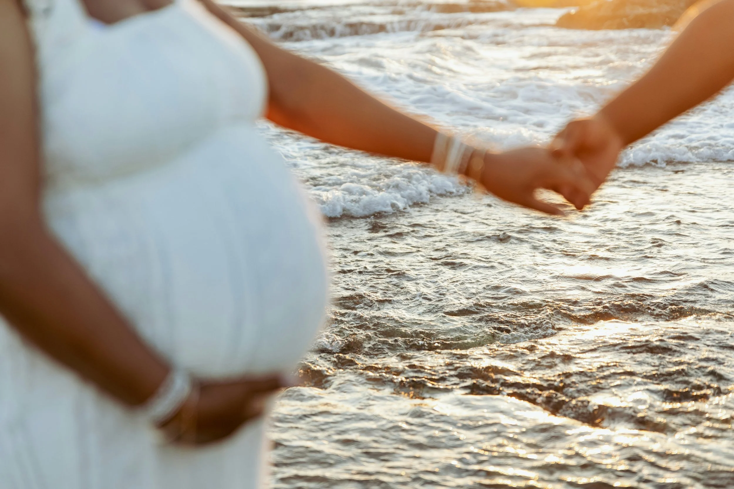 pregnant person holding a hand