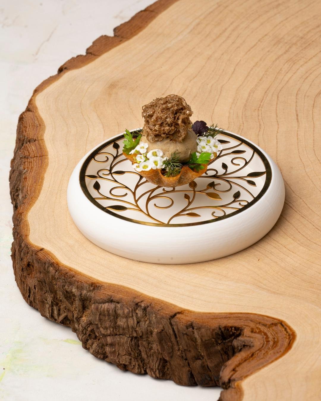 WAGYU mushroom, Sauce P&eacute;rigord

Highland Wagyu sirloin paired with a braised rump beignet, finished with delicate P&eacute;rigord truffle. Served with silky mushroom and black garlic pur&eacute;es, with rich truffle beef jus poured to finish.
