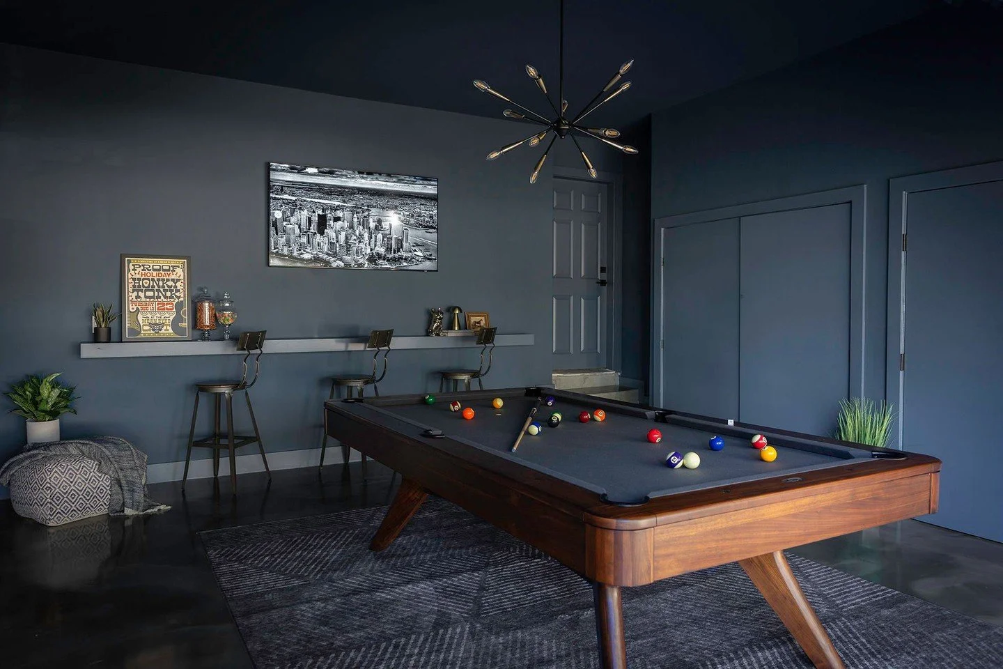 🎲 It's Game night! This garage underwent a dramatic transformation. We went from grimy garage to moody game room by color drenching the whole space with Van Deusen Blue, adding metallic epoxy flooring, and so much more. Our clients envisioned a spac