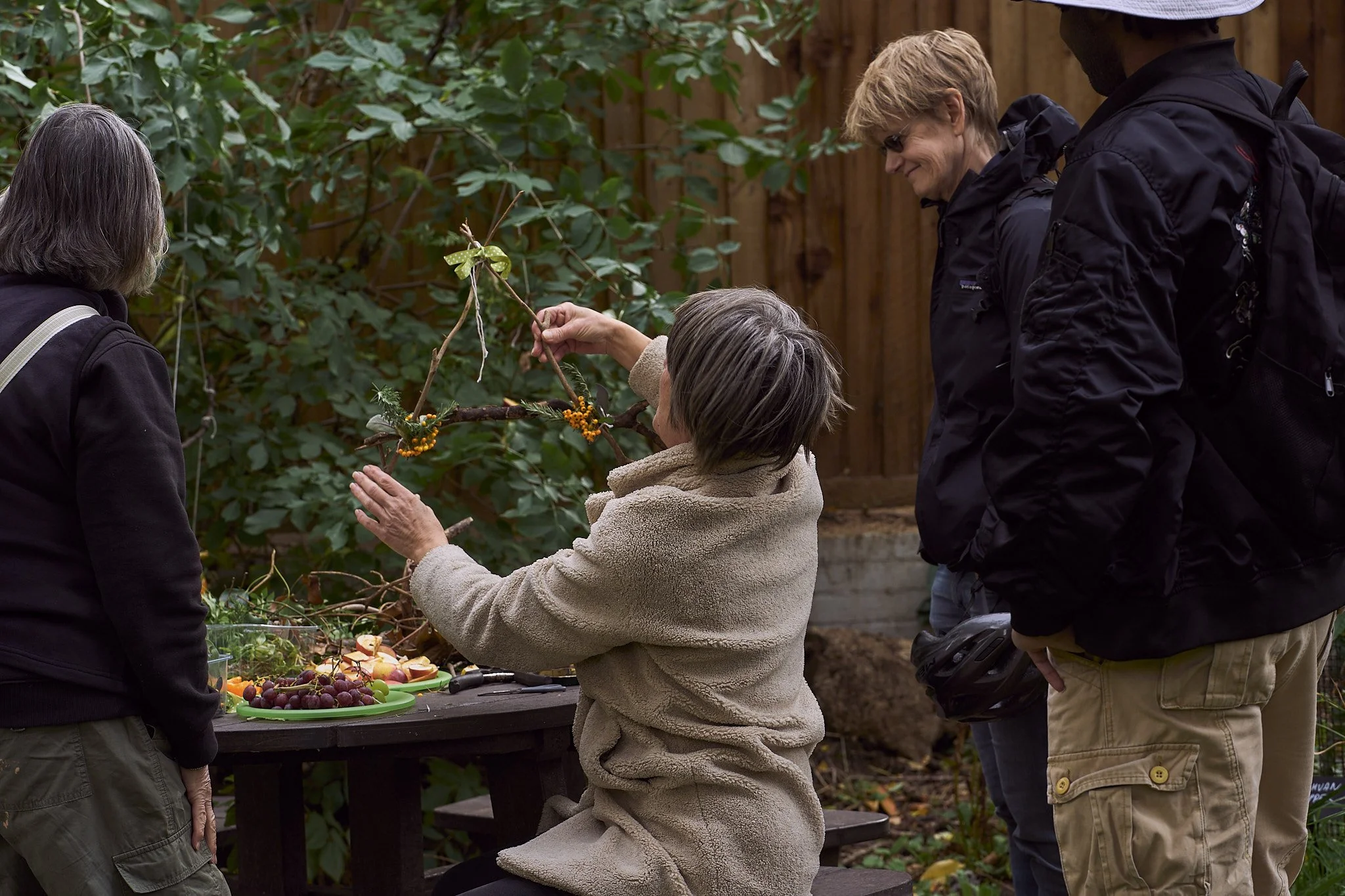 Group in the Woodland Garden, holding up a nature mobile
