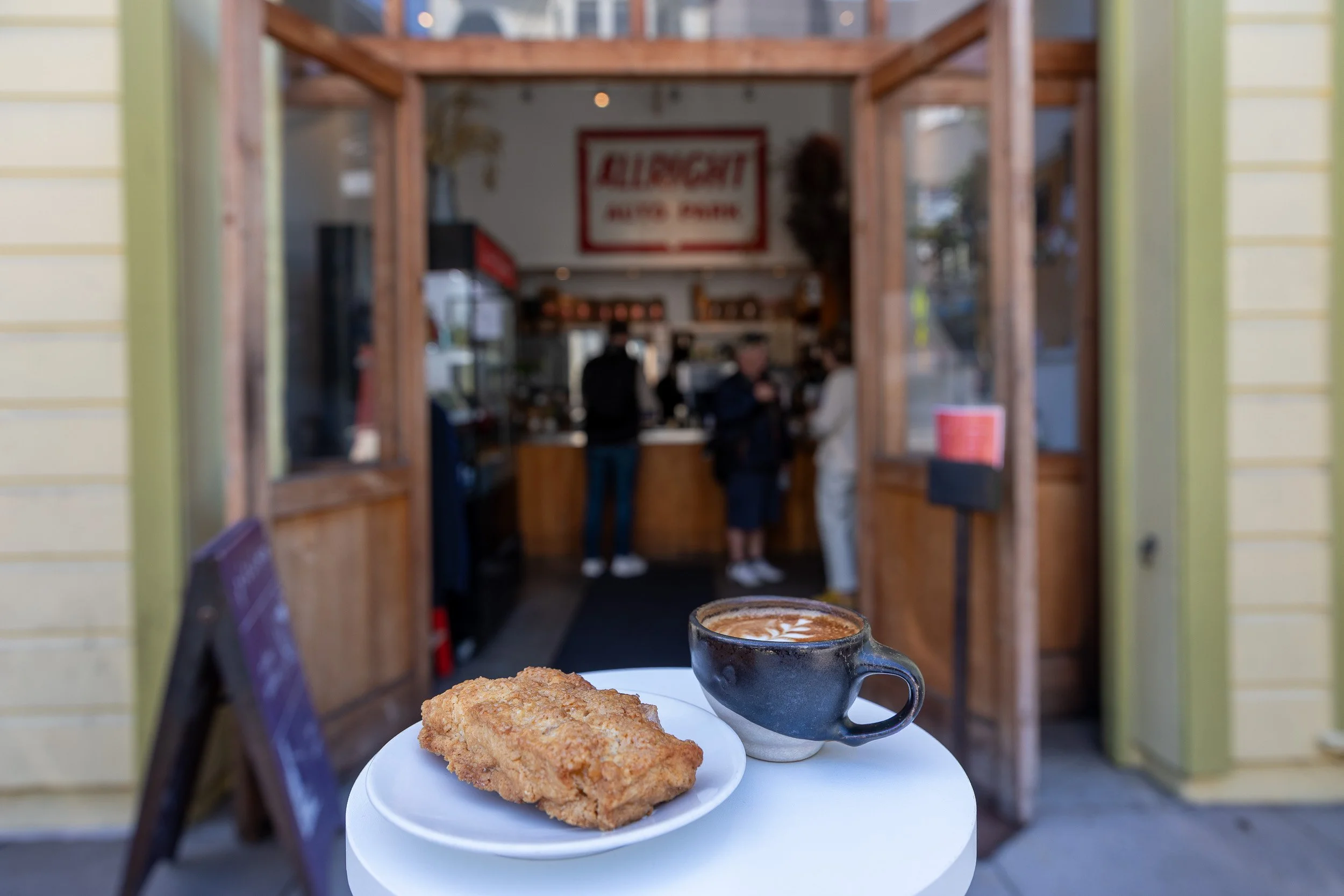 A ginger scone and espresso drink in front of Piccino Coffee Bar