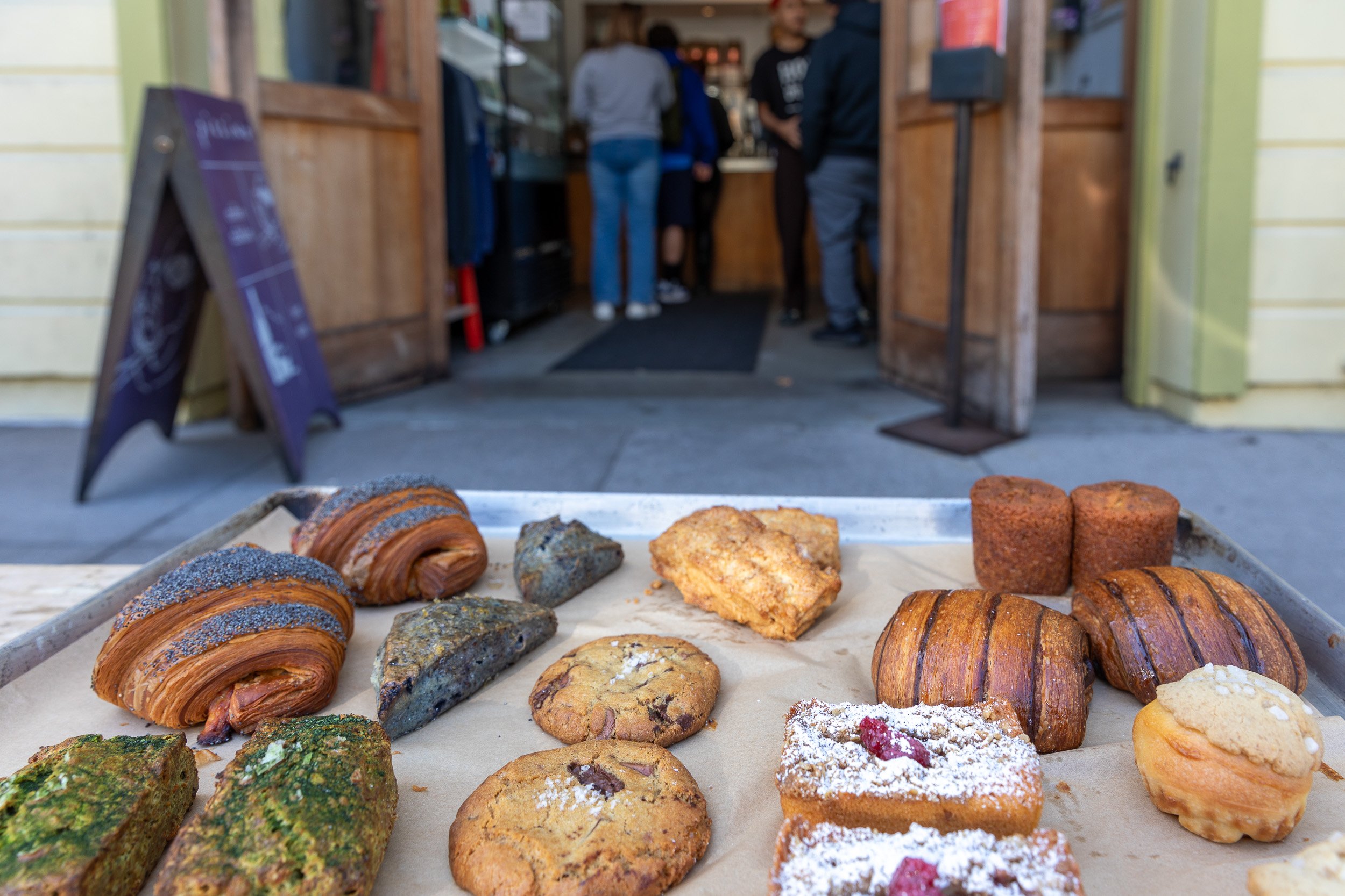 A fleet of pastries on a baking tray in front of Piccino Coffee Bar