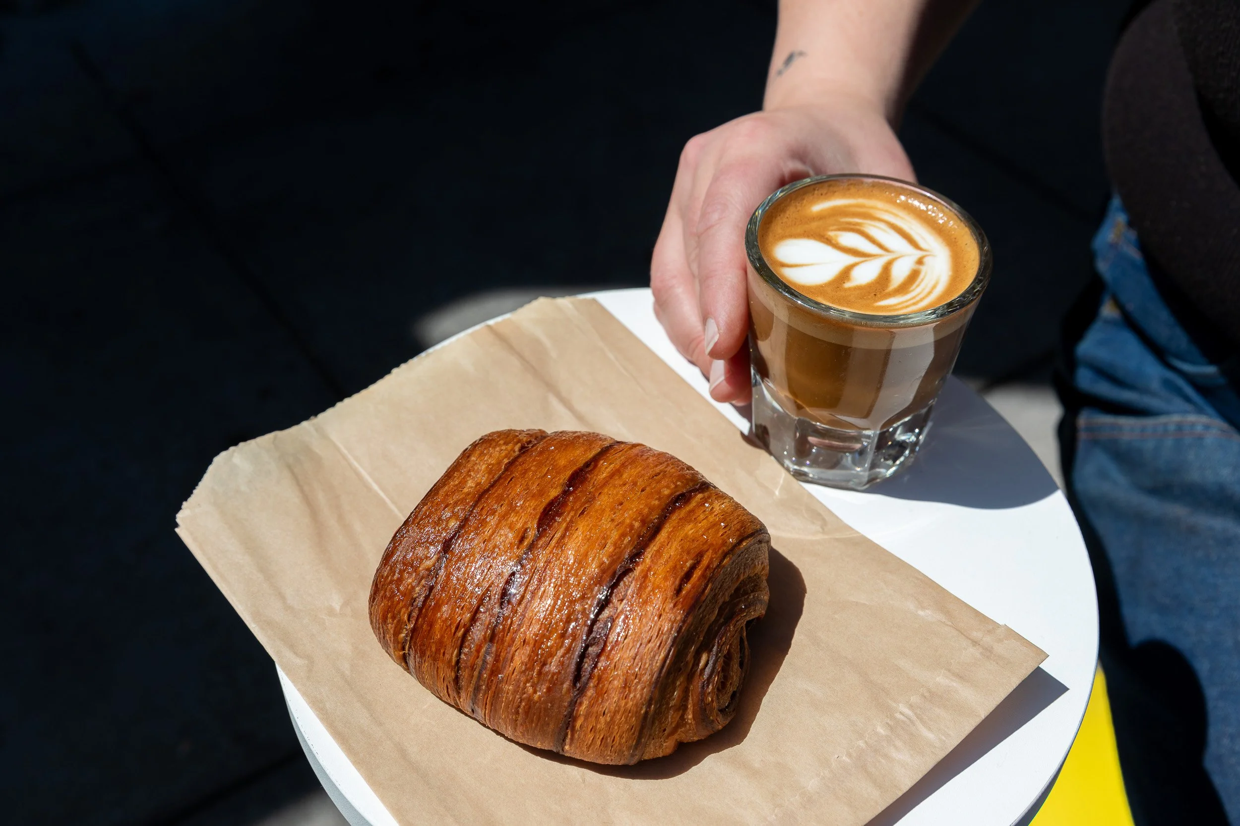 A chocolate croissant and a macchiato coffee.
