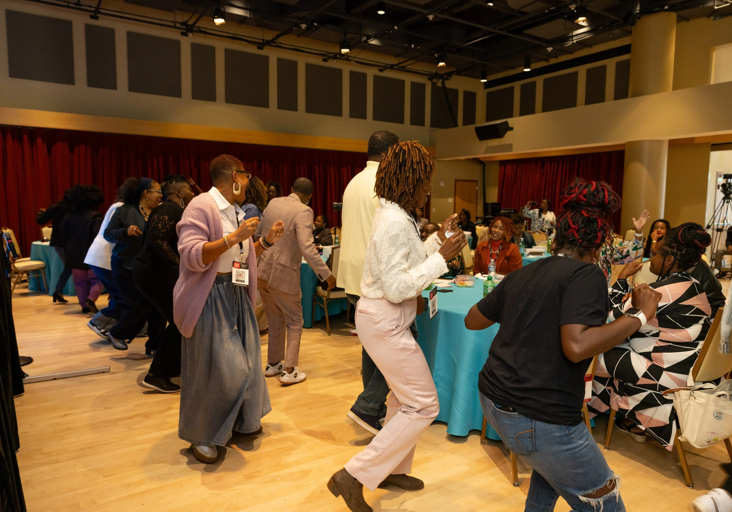 Attendees on their feet dancing at the BLCK Street Summit, an annual gathering for Black business owners in Richmond, VA