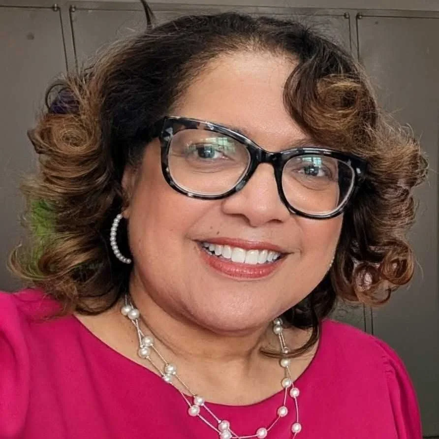Lisa Townes, Director of Programs for BLCK Street. Lisa is smiling with a pink blouse and glasses
