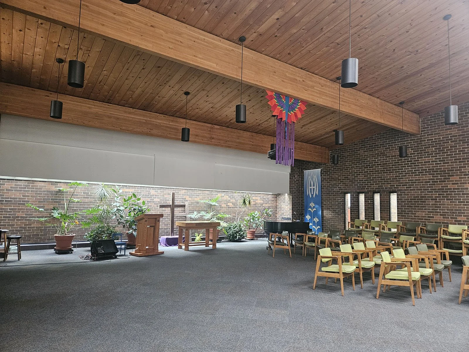 Interior of Church of the Three Crosses showing the wide sanctuary space and beautiful wooden beams. There is enough space here for a production!
