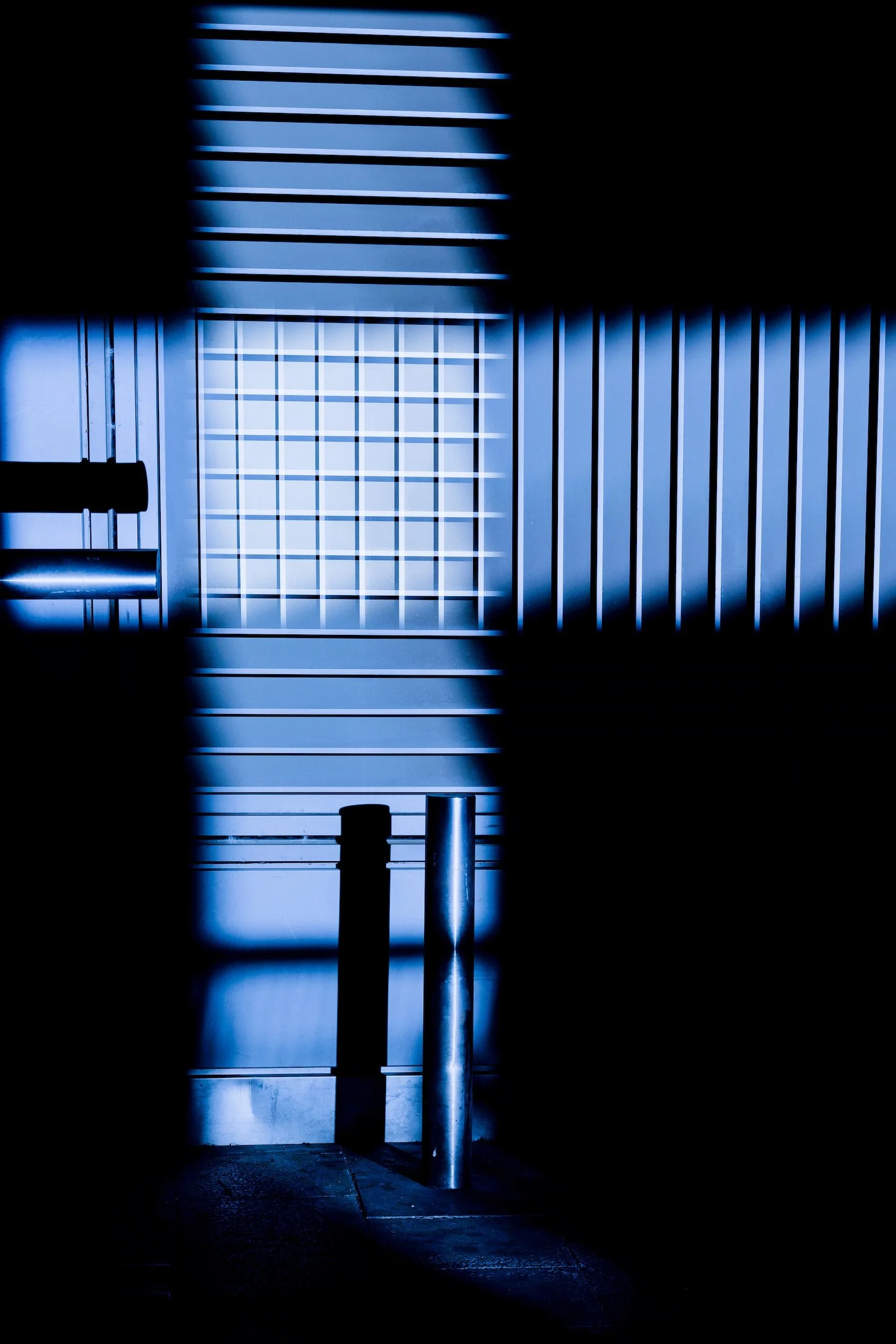 Abstract composition of metal cylinders and vertical lines with shadows