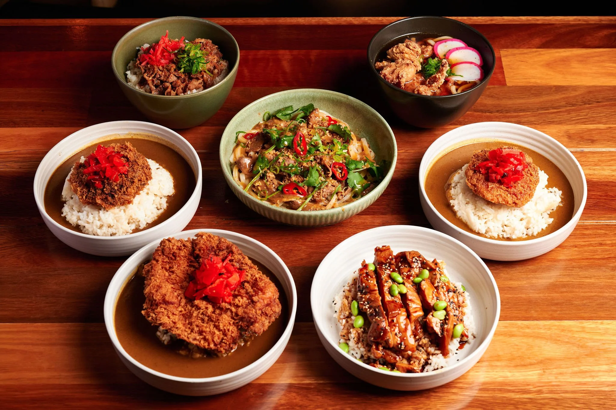Table with range of Harajuku Gyoza rice bowls and noodles
