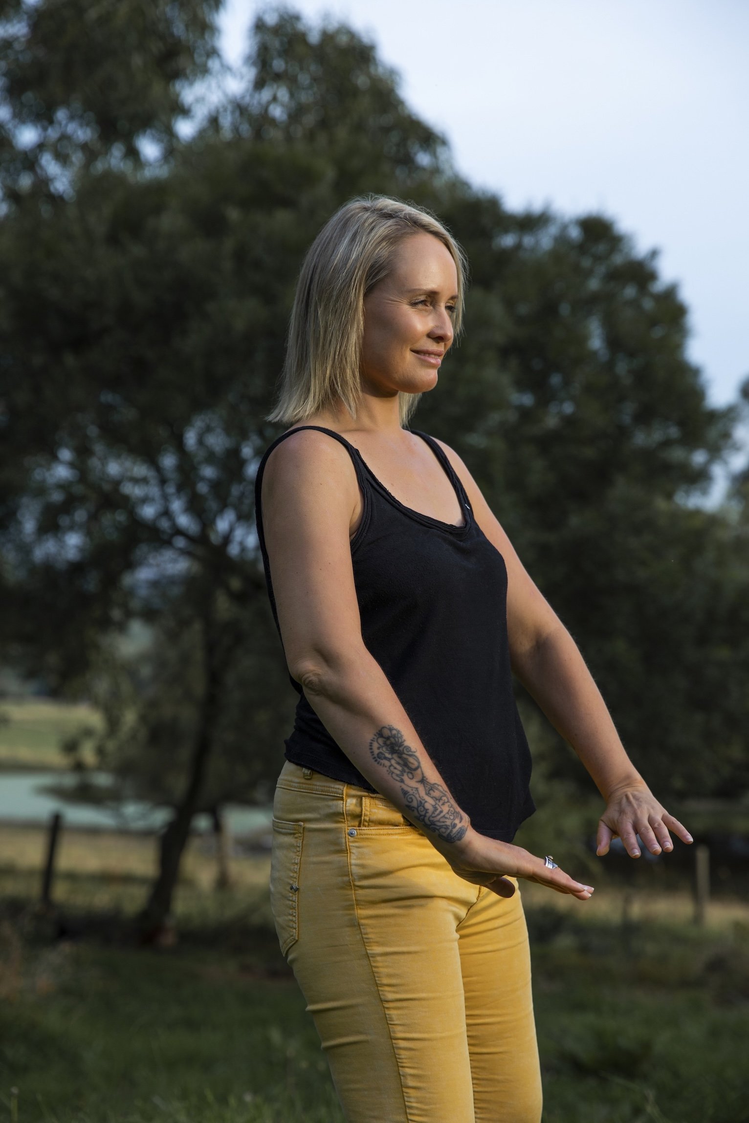 Woman practising Metal Element Qigong outdoors