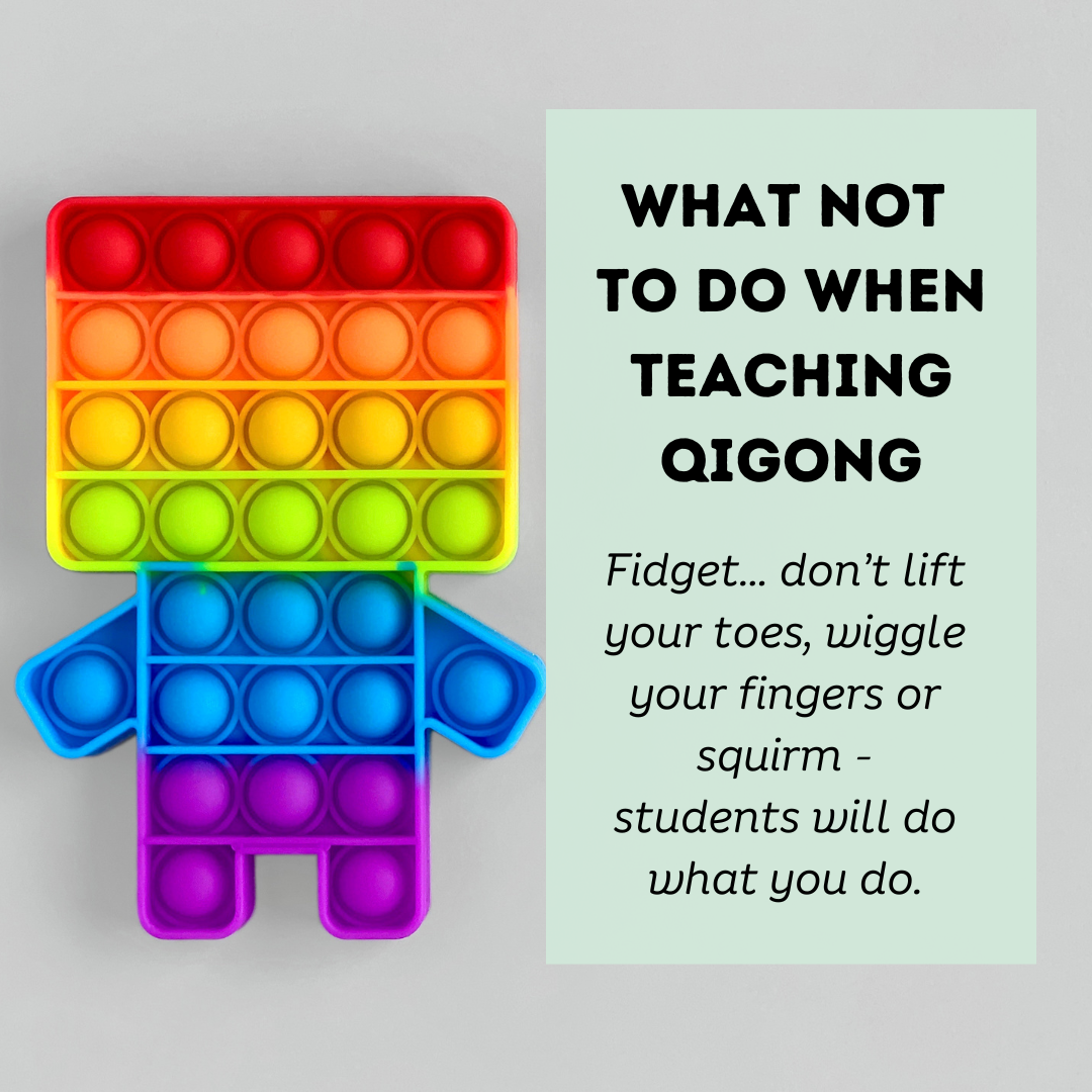 Rainbow pop-it figure with text reading “What not to do when teaching Qigong: Fidget... don’t lift your toes, wiggle your fingers or squirm - students will do what you do.”