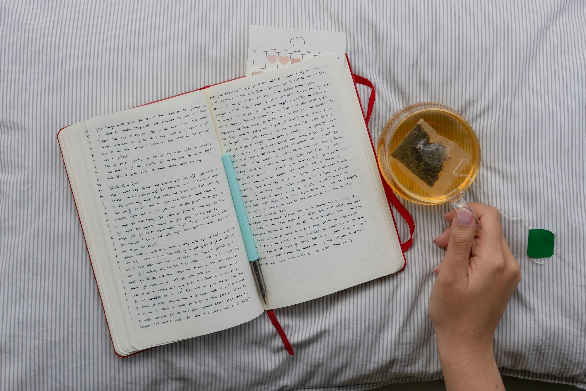 Open journal and cup of tea symbolising a daily Qigong practice of reflection, self-cultivation, and building a lifelong relationship with practice.