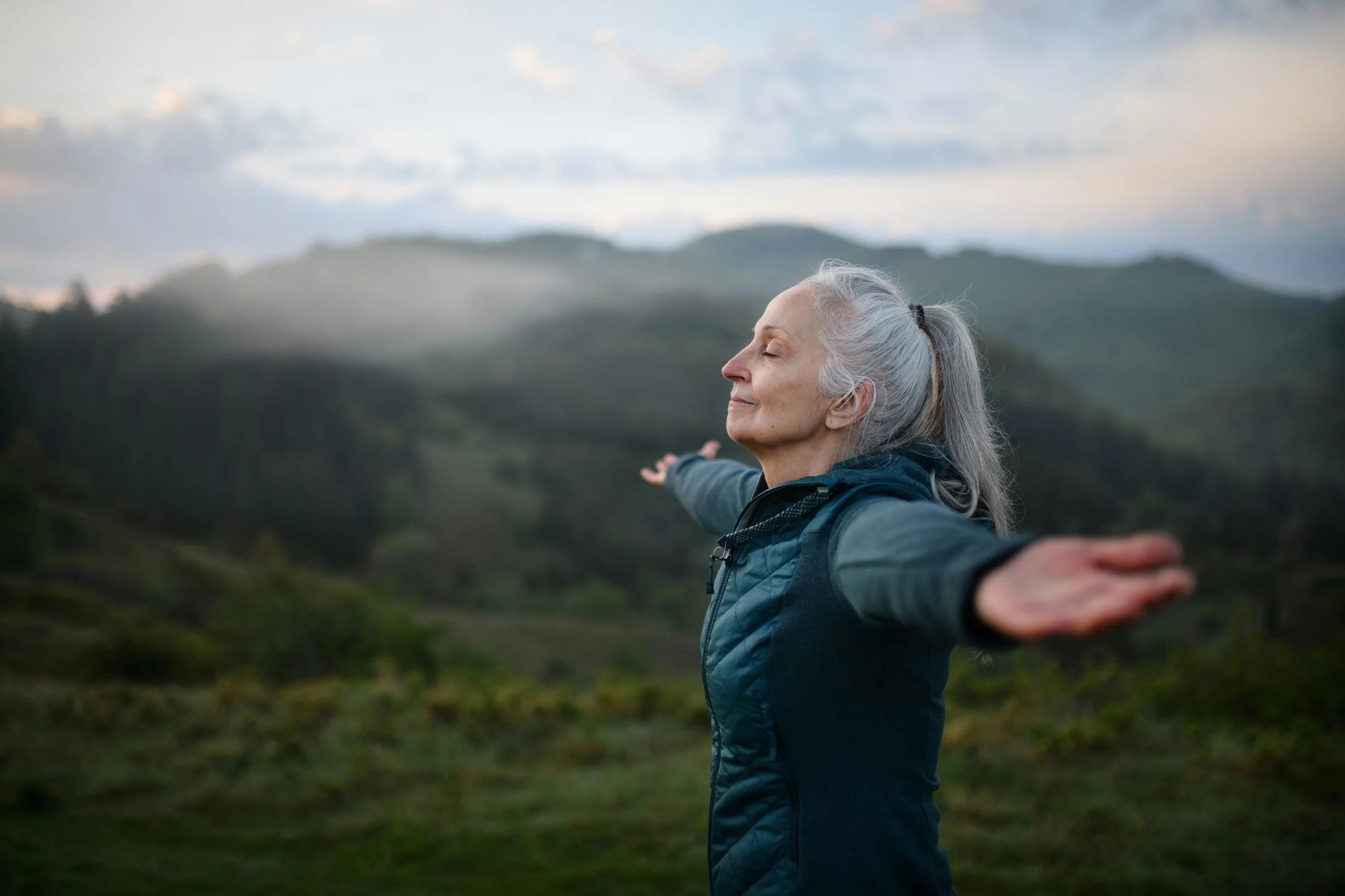 Woman in nature representing Qigong support for perimenopausal anxiety and wellbeing