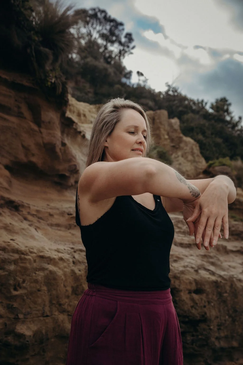 Nicole Lee practising Qigong for Inner Revolution outdoors, moving with awareness and attention to the body and breath.