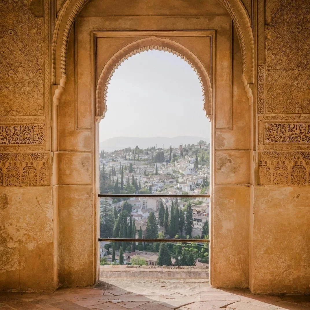 Arched window overlooking a peaceful landscape