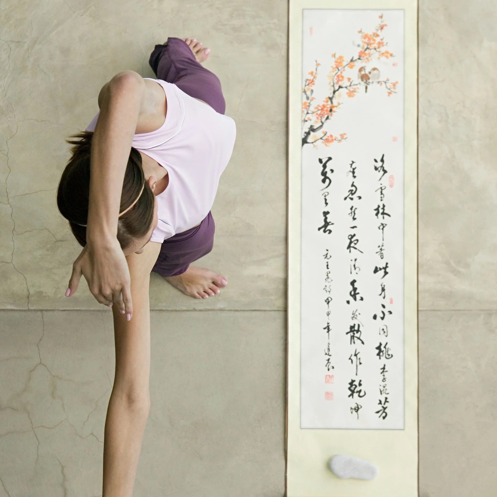 Overhead view of a woman practising slow, mindful movement with focus on body awareness