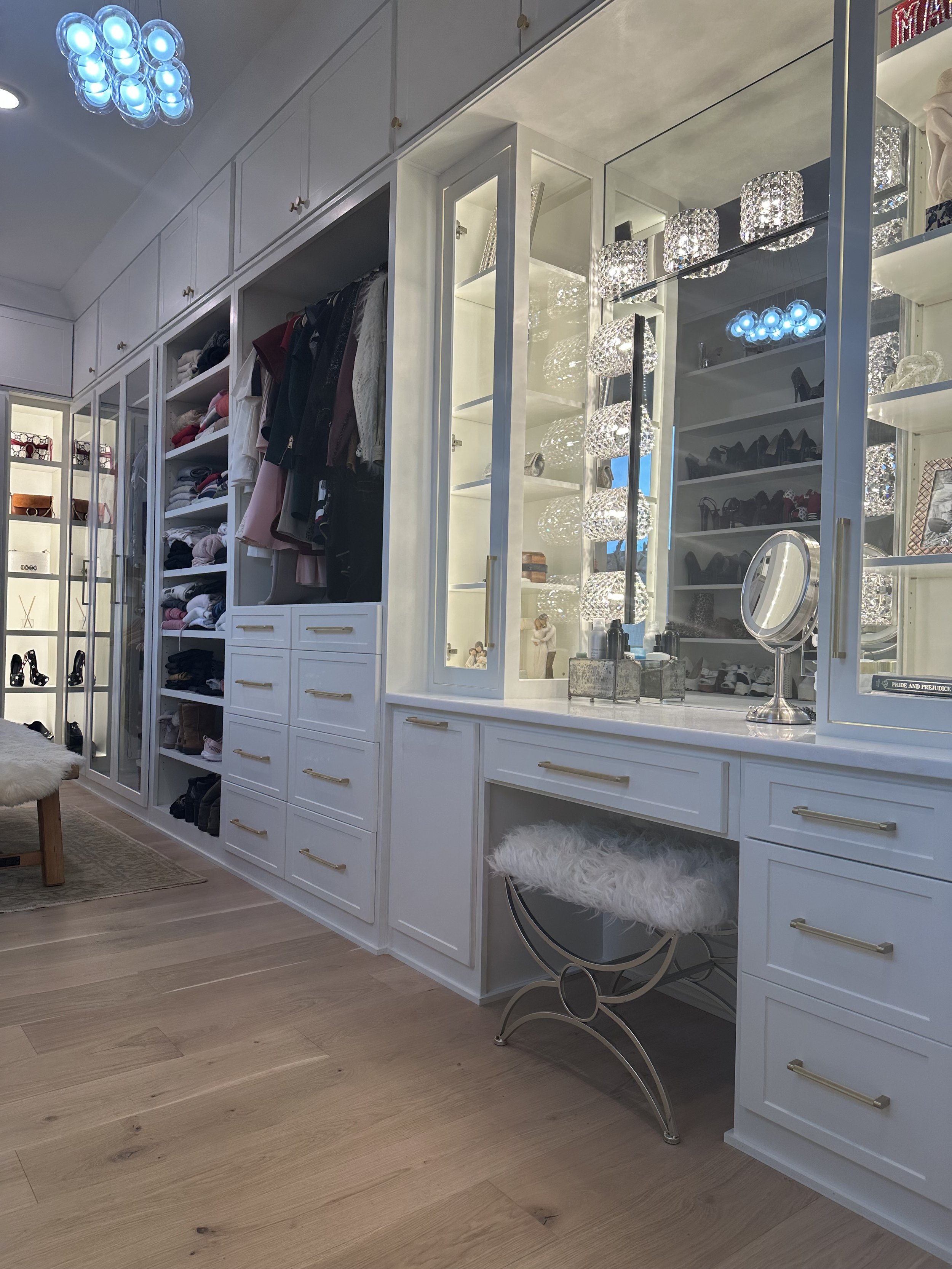 Massive custom closet with glass doors, Led lit display cabinets, all custom to the space. 